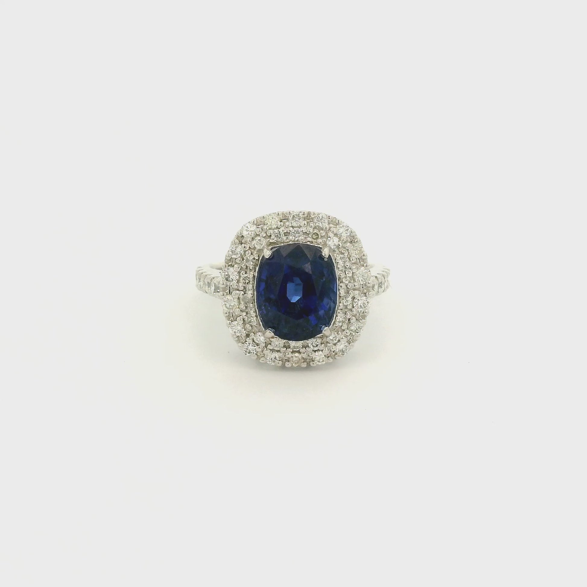 A Platinum Ring with a Prong set oval cut natural GIA certified Sapphire in the center with a halo of pavé diamonds at Forever Rox Fine Jewelry, Lake Tahoes Best Jewelry Store
