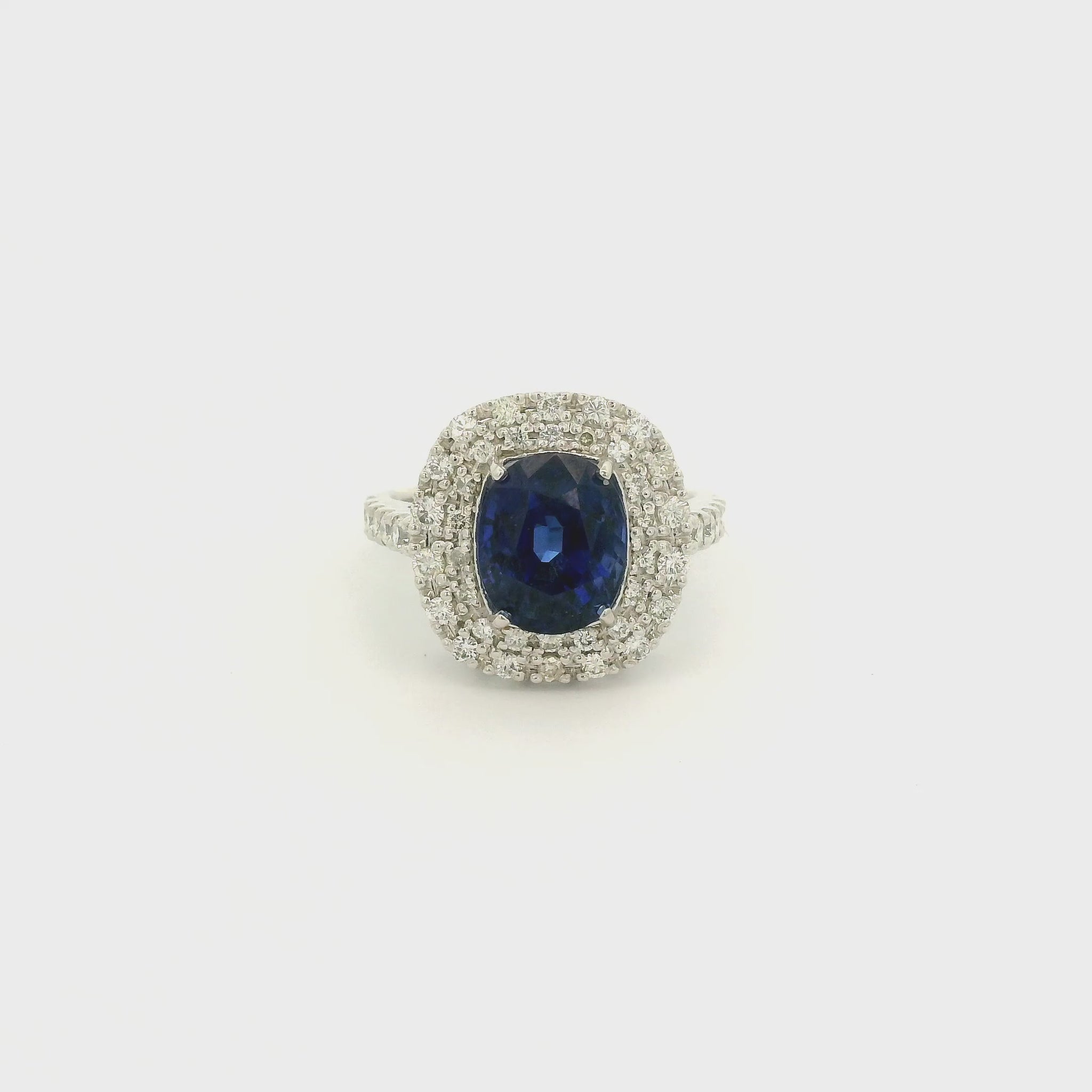 A Platinum Ring with a Prong set oval cut natural GIA certified Sapphire in the center with a halo of pavé diamonds at Forever Rox Fine Jewelry, Lake Tahoes Best Jewelry Store
