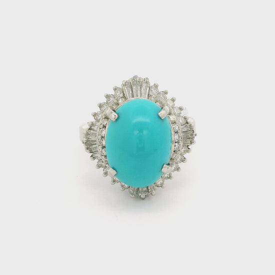 A Platinum Ring with a prong set oval Turquoise in the center with Baguette & Round cut Diamonds in a halo at Forever Rox Fine Jewelry, Lake Tahoes Best Jewelry Store