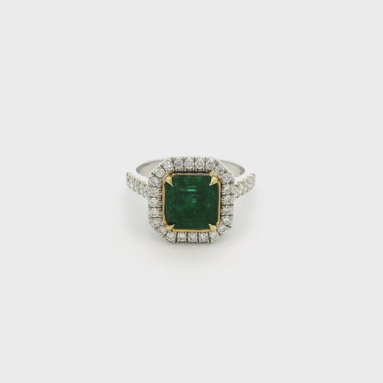 A White Gold Ring with a prong set square emerald cut Emerald in the center with a halo of diamonds and diamonds down shank at Forever Rox Fine Jewelry, Lake Tahoes Best Jewelry Store