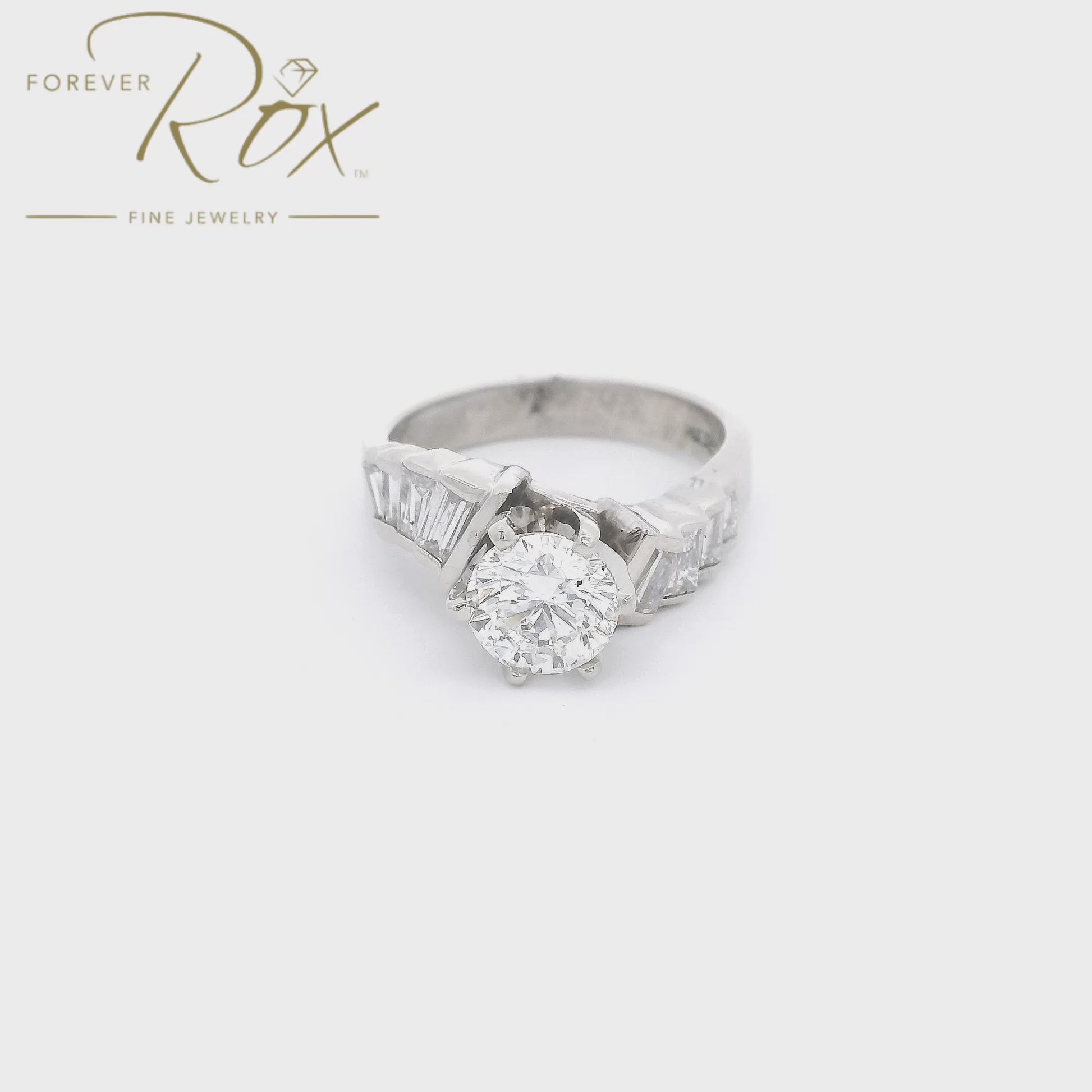A White Gold Wedding Bridal Ring with a prong set 1.17ct round cut Diamond in the center with 4 baguette cut diamonds down the curved shank at Forever Rox Fine Jewelry, Lake Tahoes Best Jewelry Store