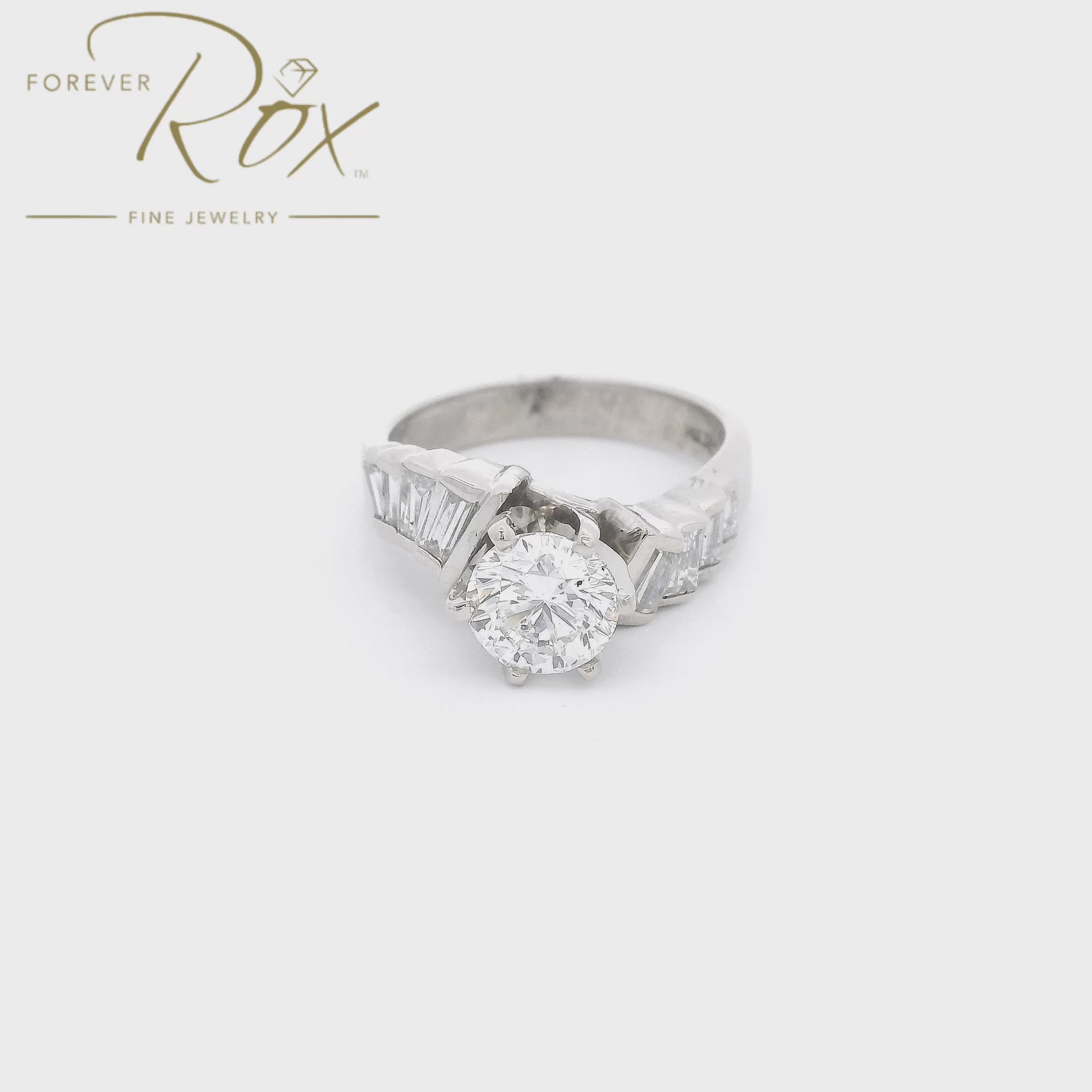 A White Gold Wedding Bridal Ring with a prong set 1.17ct round cut Diamond in the center with 4 baguette cut diamonds down the curved shank at Forever Rox Fine Jewelry, Lake Tahoes Best Jewelry Store