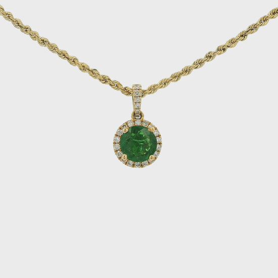 A Yellow Gold Pendant with a prong set round cut natural Tsavorite Garnet in the center with a halo of diamonds and diamond bail at Forever Rox Fine Jewelry, Lake Tahoes Best Jewelry Store.