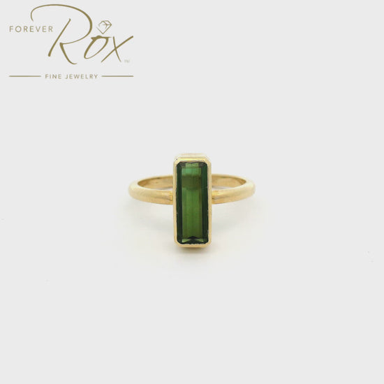 A Yellow Gold Ring with a bezel set elongated step cut green Tourmaline in the center at Forever Rox Fine Jewelry, Lake Tahoes Best Jewelry Store
