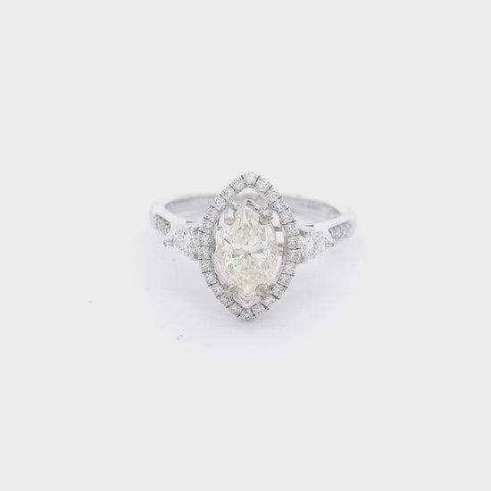 Marquise cut diamond bradal ring with a diamond halo and d2 smaller round diamonds nect to the head at Forever Rox Fine Jewelry