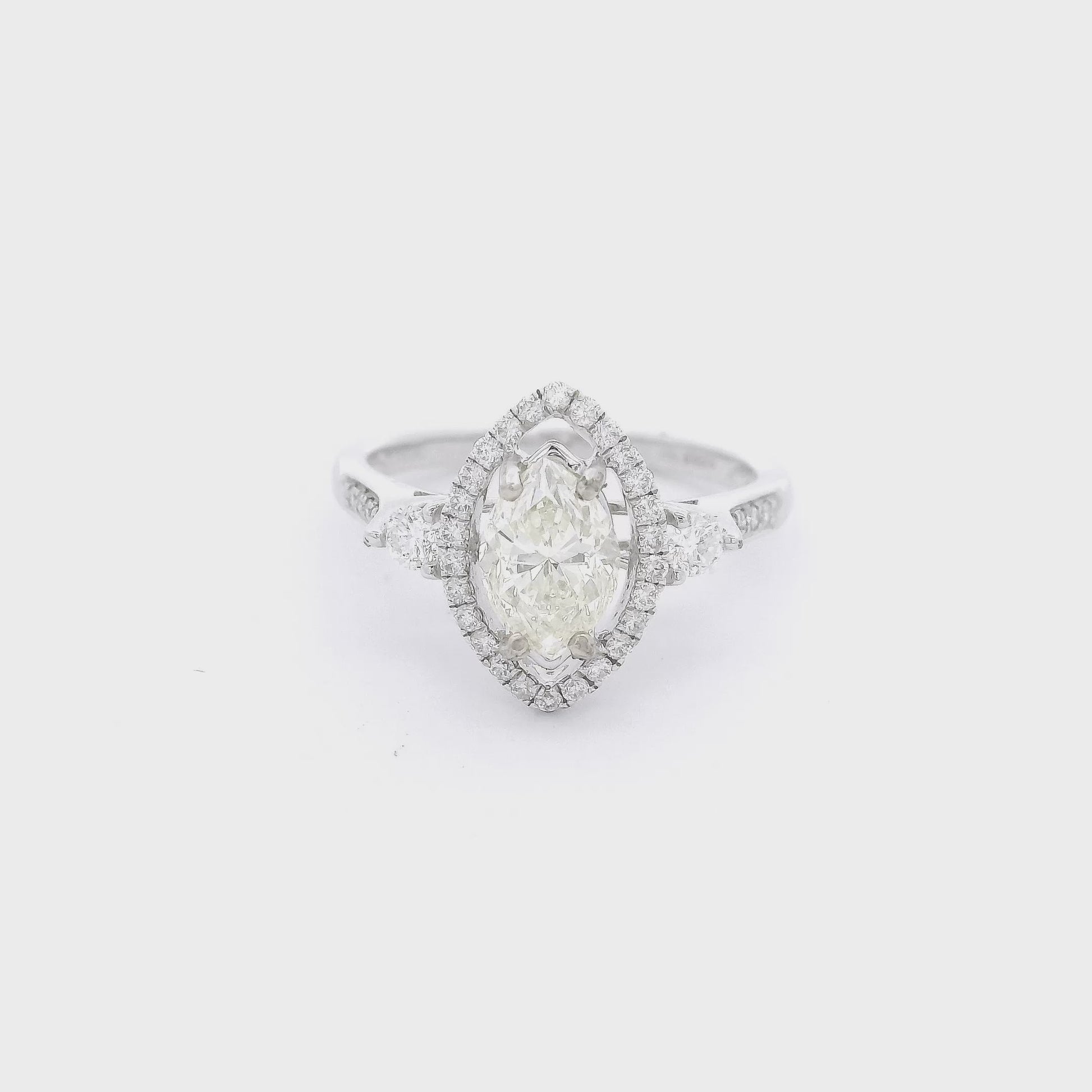 Marquise cut diamond bradal ring with a diamond halo and d2 smaller round diamonds nect to the head at Forever Rox Fine Jewelry