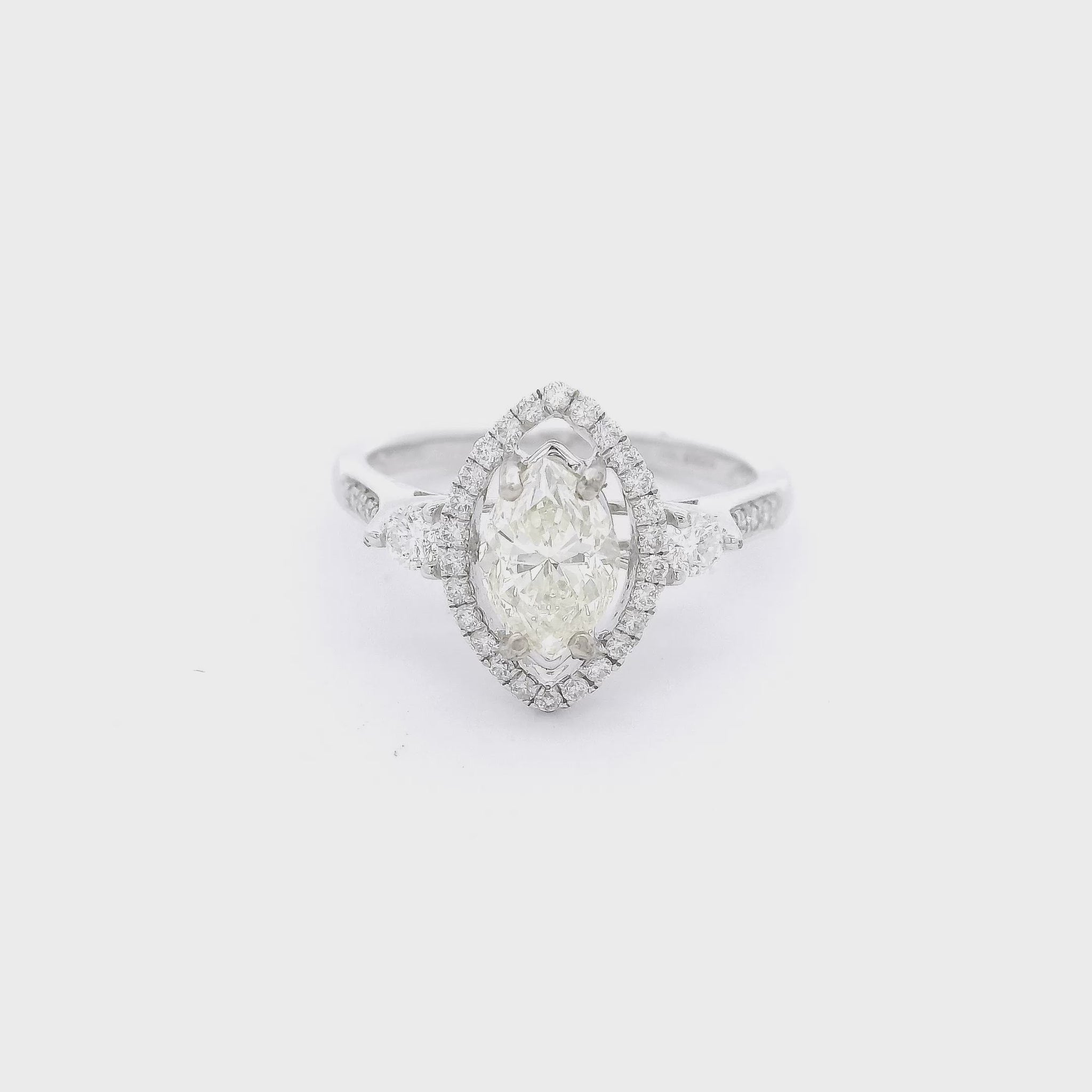 Marquise cut diamond bradal ring with a diamond halo and d2 smaller round diamonds nect to the head at Forever Rox Fine Jewelry