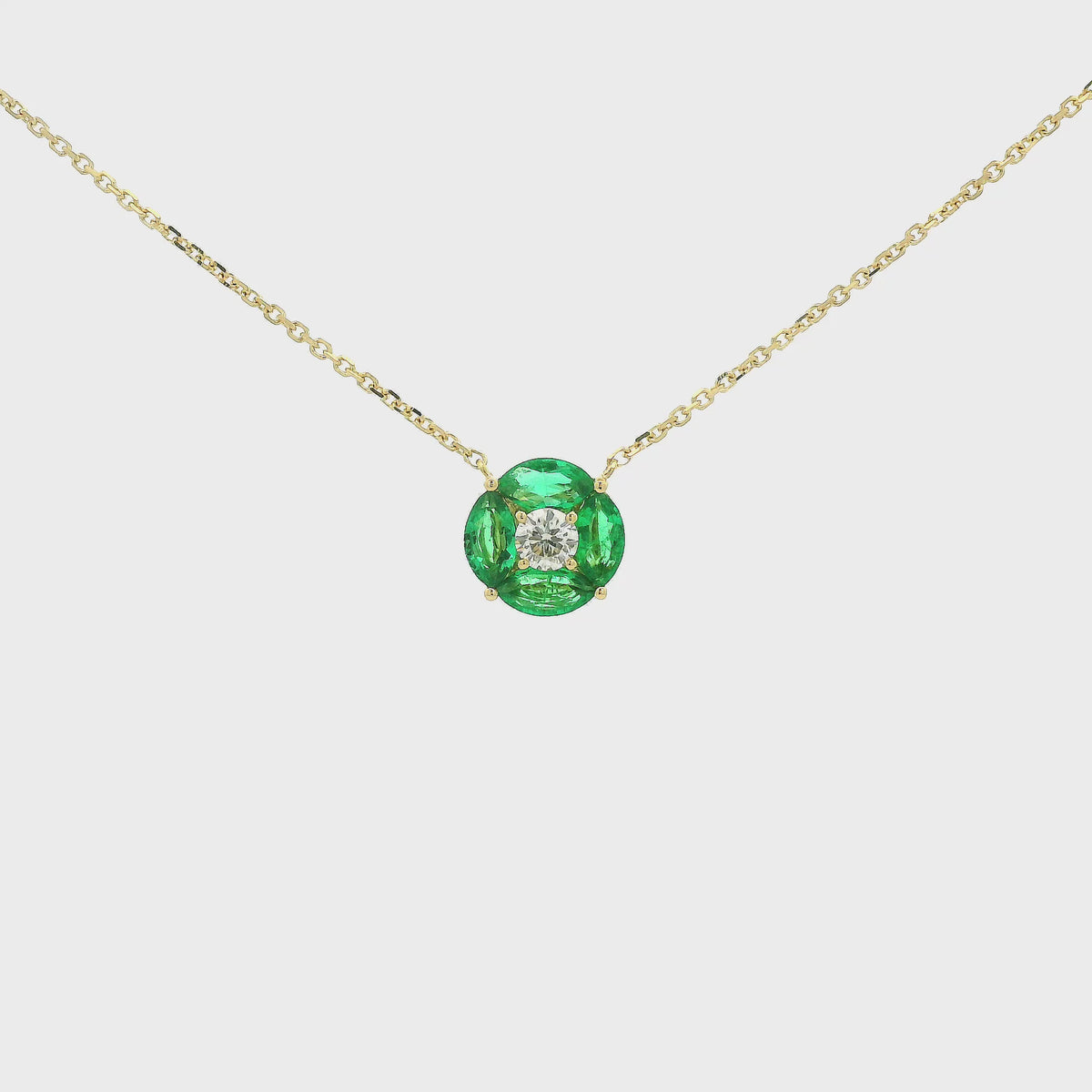 A Yellow Gold Pendant with a round cut diamond in the center & 4 marquise cut emeralds in a circle around it at Forever Rox Fine Jewelry, Lake Tahoes Best Jewelry Store