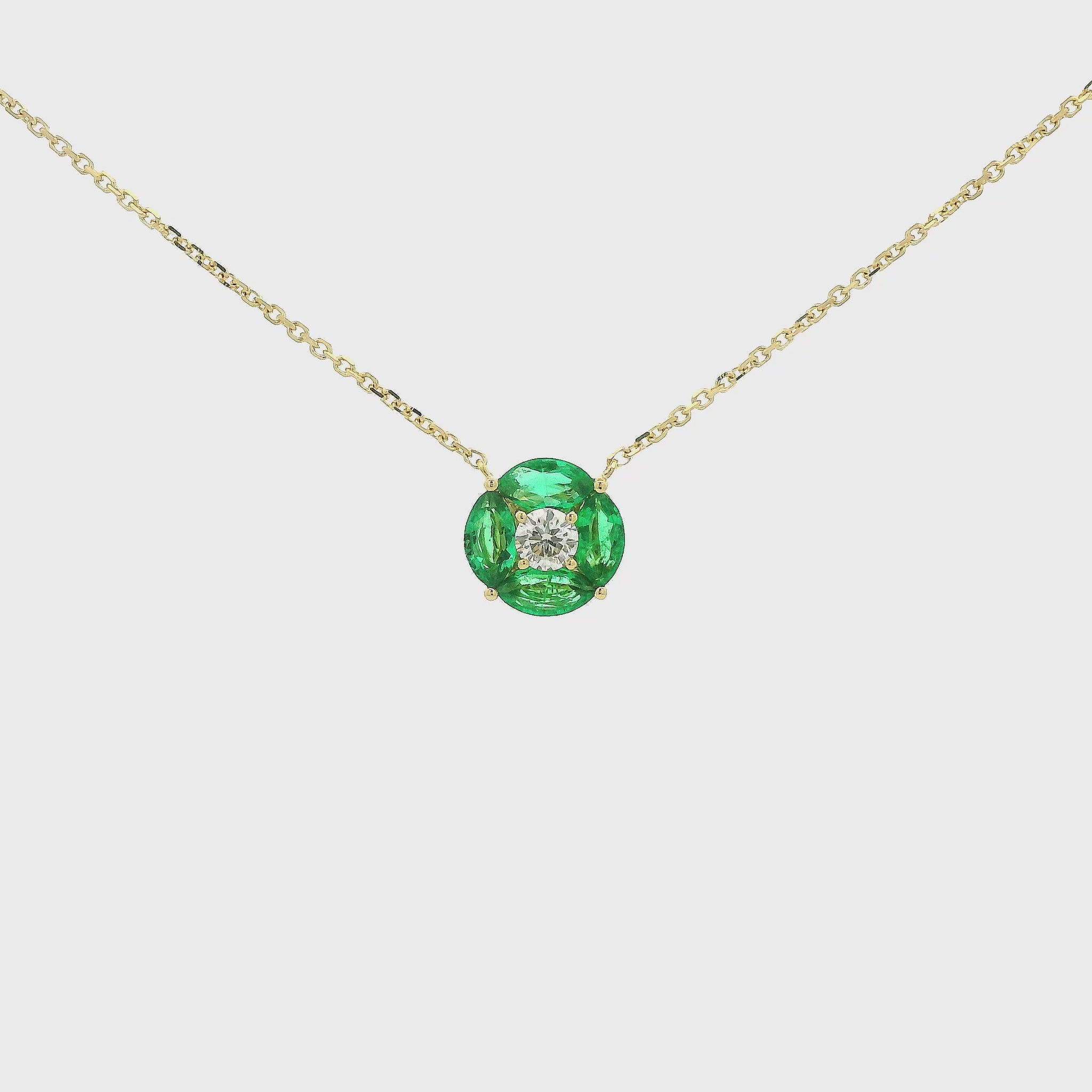 A Yellow Gold Pendant with a round cut diamond in the center & 4 marquise cut emeralds in a circle around it at Forever Rox Fine Jewelry, Lake Tahoes Best Jewelry Store