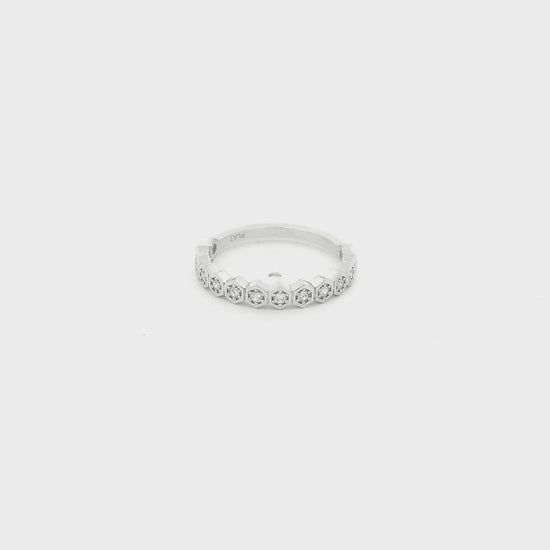 This custom platinum band features a striking row of octagon-shaped bezels, each framing a natural round brilliant cut diamond for a total of 0.18 carats of sparkle. Inspired by a matching design we carry in 14k yellow gold, this piece was custom crafted in platinum at the client’s request, giving the timeless silhouette a luxurious and enduring finish. The combination of geometric elegance, natural diamonds, and platinum’s exceptional durability makes this band a beautiful expression of personalized fine j