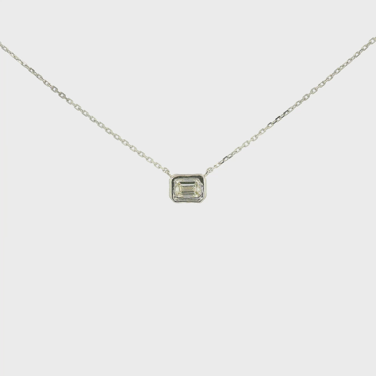 A White Gold Pendant with a bezel set emerald cut natural Diamond in the center at Forever Rox Fine Jewelry, Lake Tahoes Best Jewelry Store
