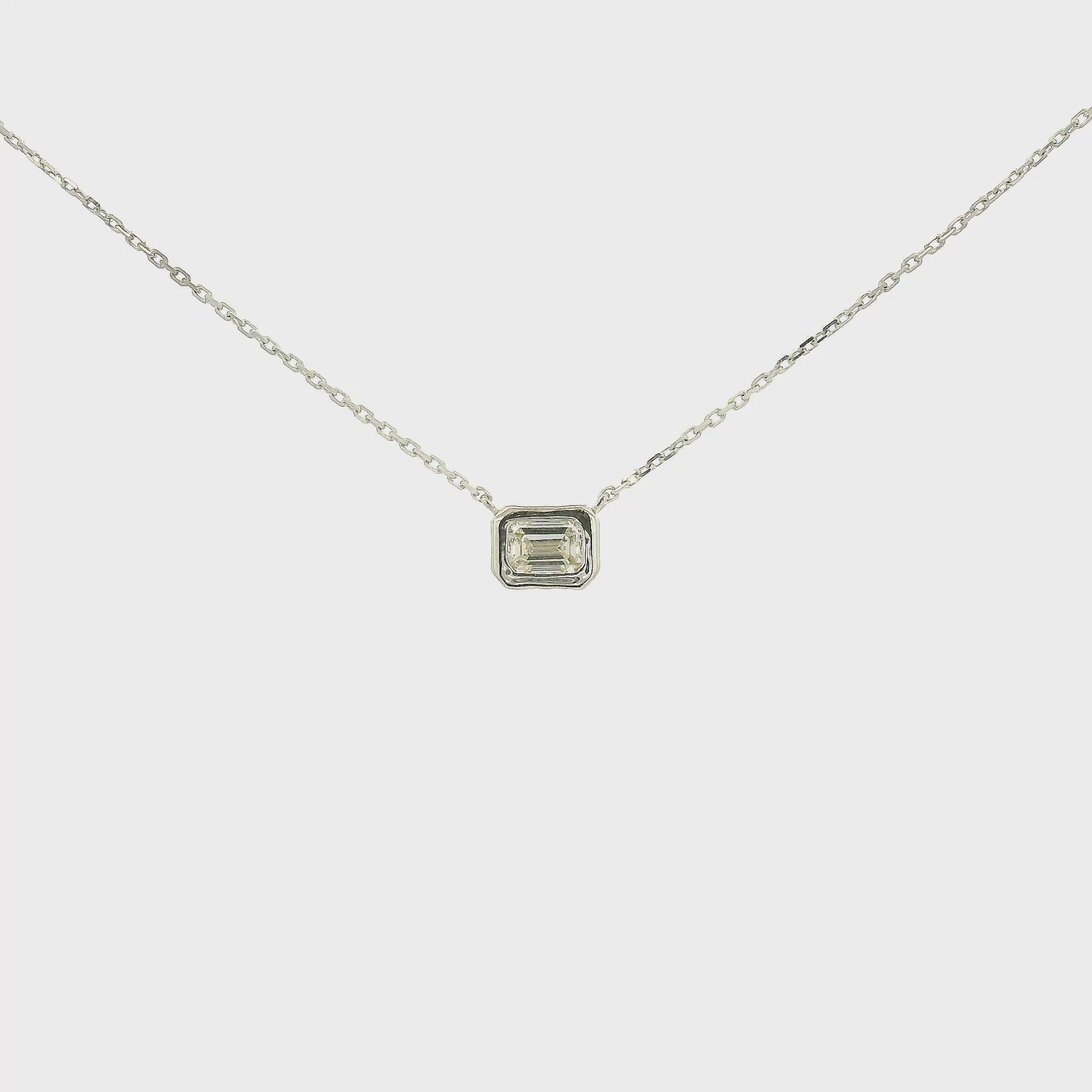 A White Gold Pendant with a bezel set emerald cut natural Diamond in the center at Forever Rox Fine Jewelry, Lake Tahoes Best Jewelry Store
