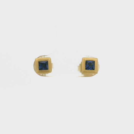 A Pair of Yellow Gold Stud Earrings with bezel set princess cut natural Sapphires in the center at Forever Rox Fine Jewelry, Lake Tahoes Best Jewelry Store