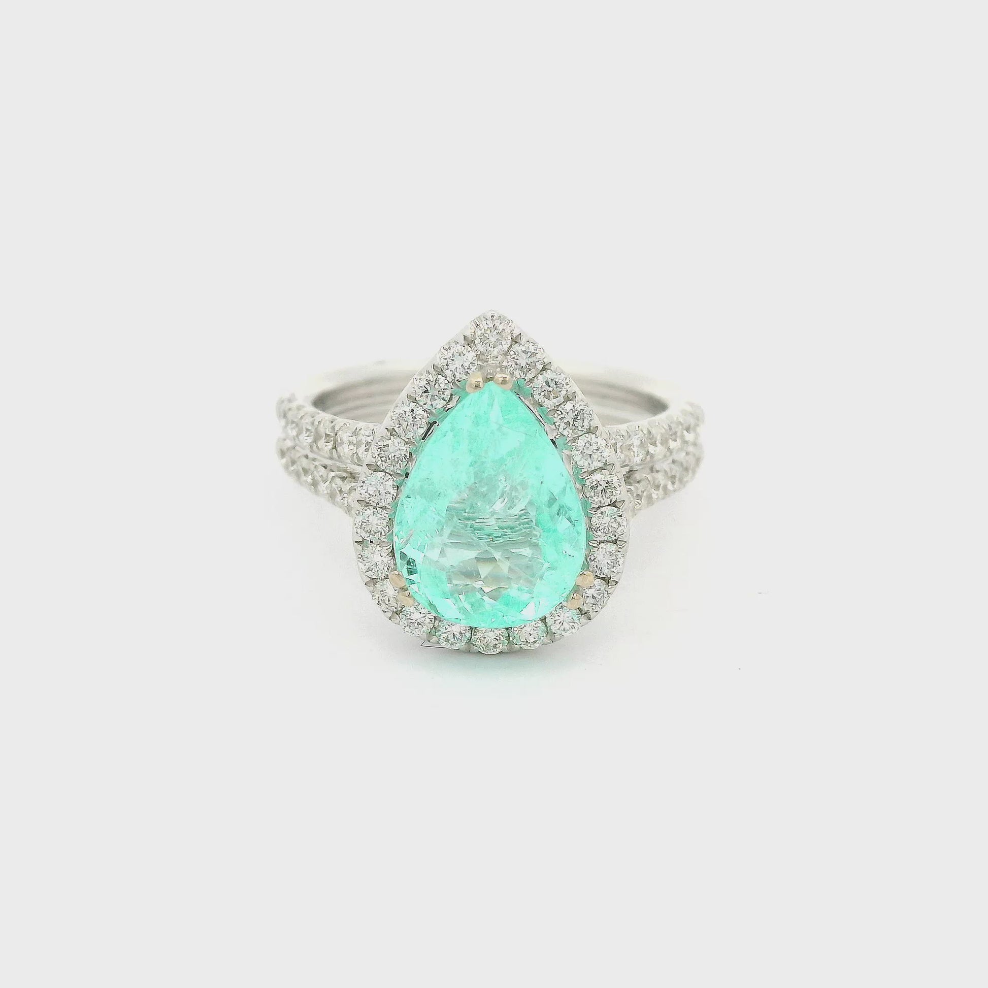 Electric Blue Pear Shape Paraiba Tourmaline set in a white gold ring with diamonds. Forever Rox Fine Jewelry