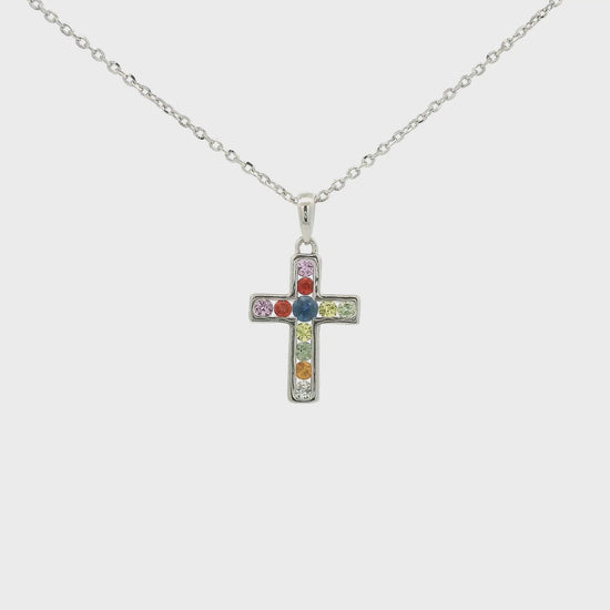 A White Gold Cross Pendant with channel set round cut blue, orange, pink, green and white Sapphires in the center  at Forever Rox Fine Jewelry, Lake Tahoes Best Jewelry Store

