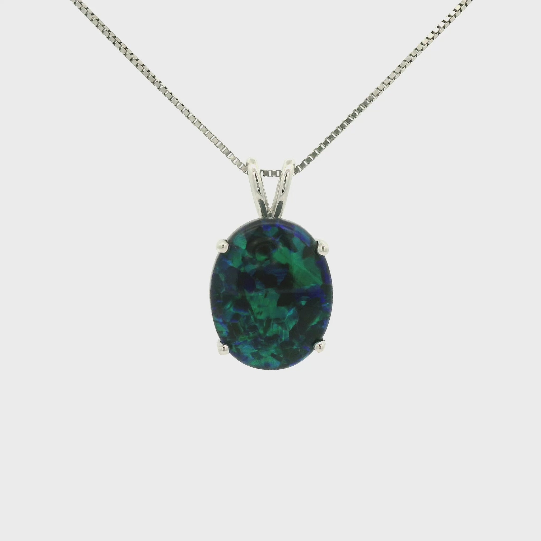 A White Gold Pendant with a prong set oval cut natural Black Lightning Ridge Opal in the center at Forever Rox Fine Jewelry, Lake Tahoes Best Jewelry Store