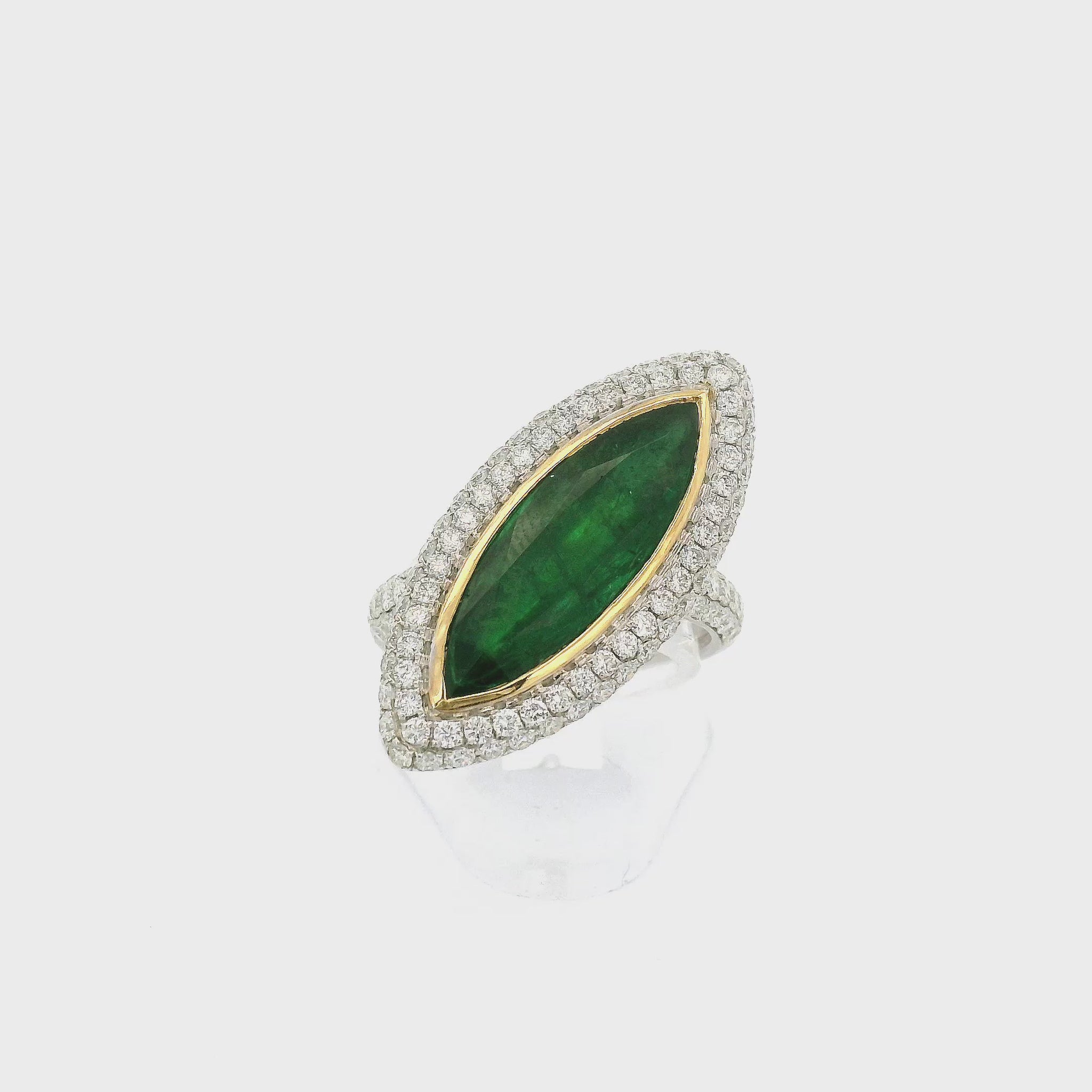 A White and Yellow Gold Ring with a bezel set long marquise cut Emerald in the center diamonds around the center and down the shank at Forever Rox Fine Jewelry, Lake Tahoes Best Jewelry Store