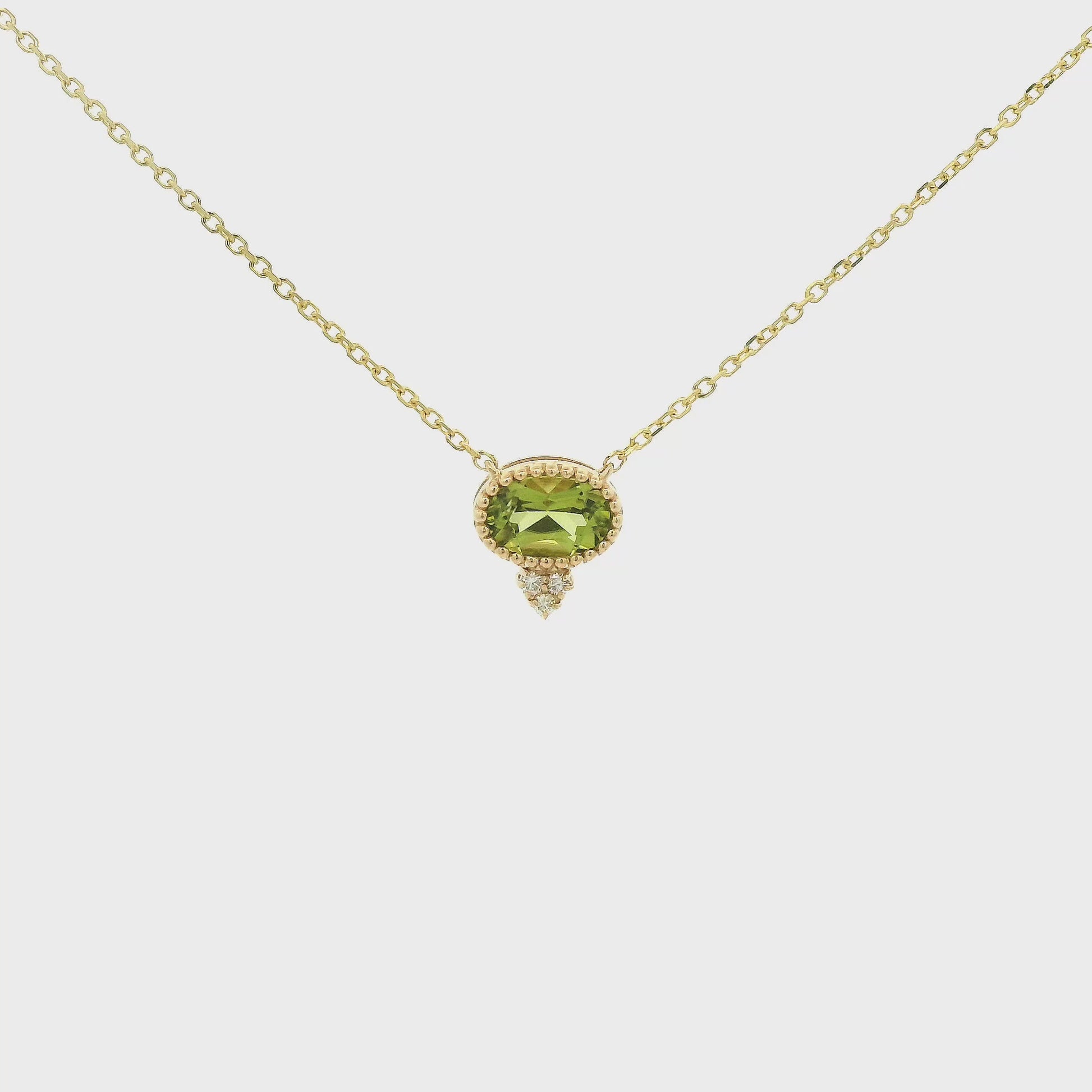 A Yellow Gold Pendant with a milgrain bezel set oval cut natural Peridot in the center with 3 diamonds and a chain attached at Forever Rox Fine Jewelry, Lake Tahoes Best Jewelry Store