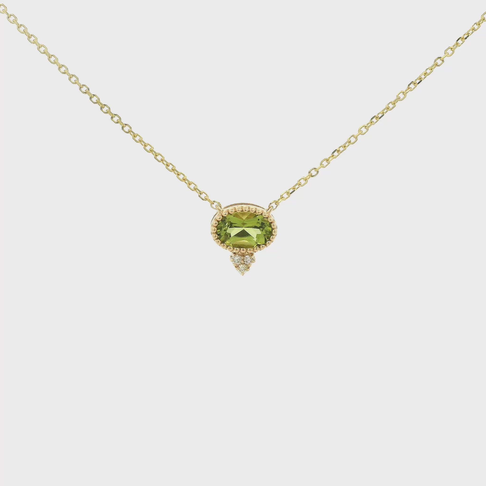 A Yellow Gold Pendant with a milgrain bezel set oval cut natural Peridot in the center with 3 diamonds and a chain attached at Forever Rox Fine Jewelry, Lake Tahoes Best Jewelry Store