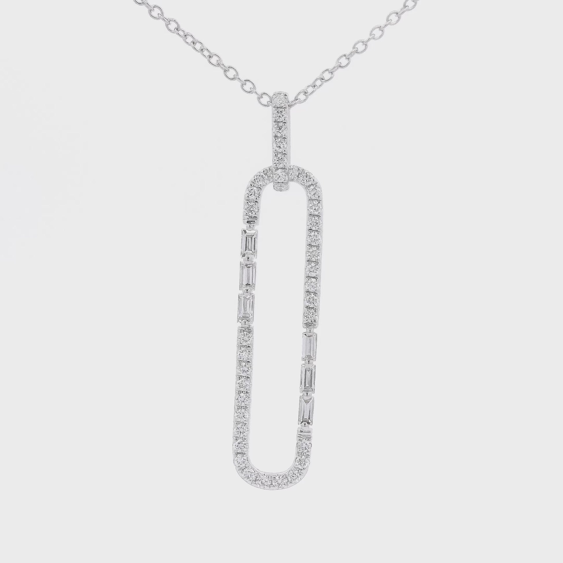 A White Gold Long Oval Shape Pendant with a round & baguette cut Diamonds around it at Forever Rox Fine Jewelry, Lake Tahoes Best Jewelry Store