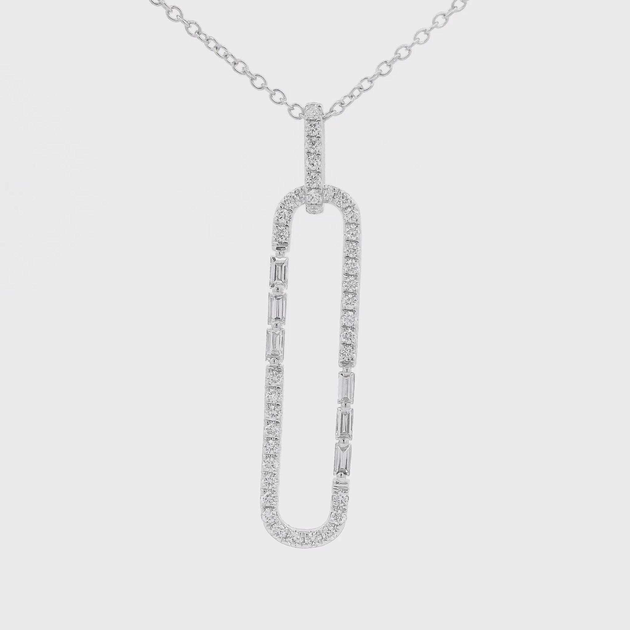 A White Gold Long Oval Shape Pendant with a round & baguette cut Diamonds around it at Forever Rox Fine Jewelry, Lake Tahoes Best Jewelry Store