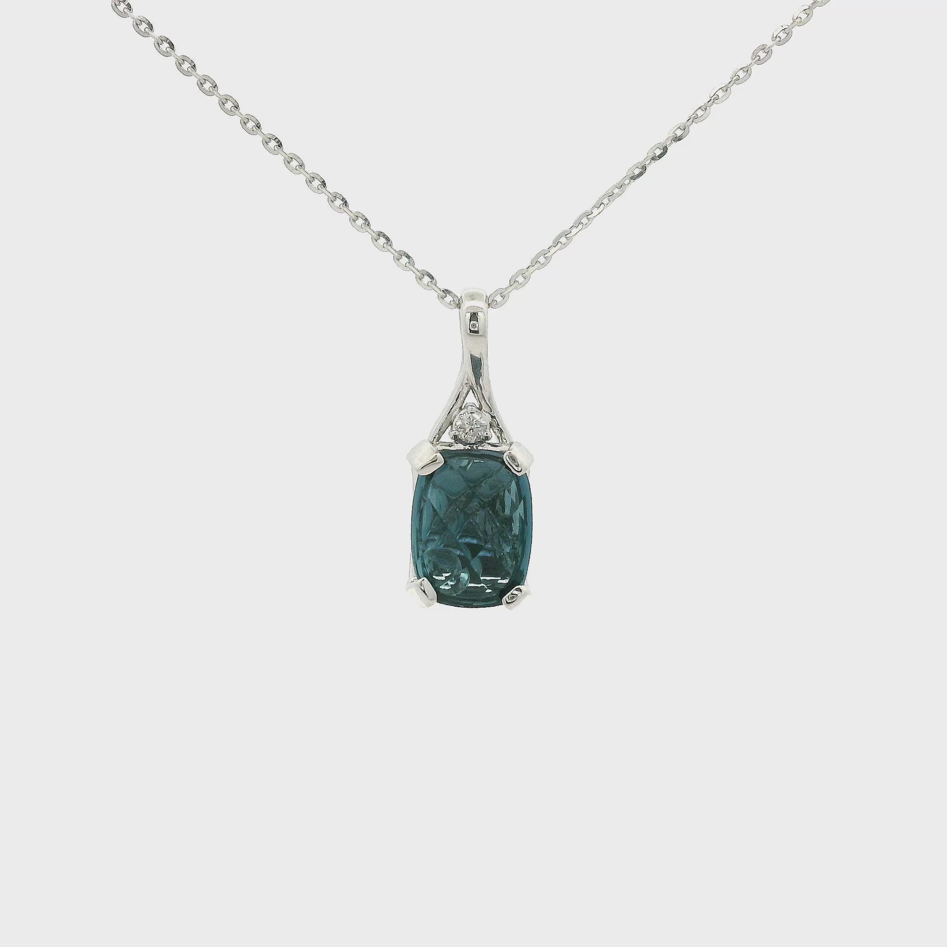 A White Gold Pendant with a prong set oval cut London Blue Topaz in the center with a bead behind it to help it sparkle and a Diamond set above the Topaz at Forever Rox Fine Jewelry, Lake Tahoes Best Jewelry Store