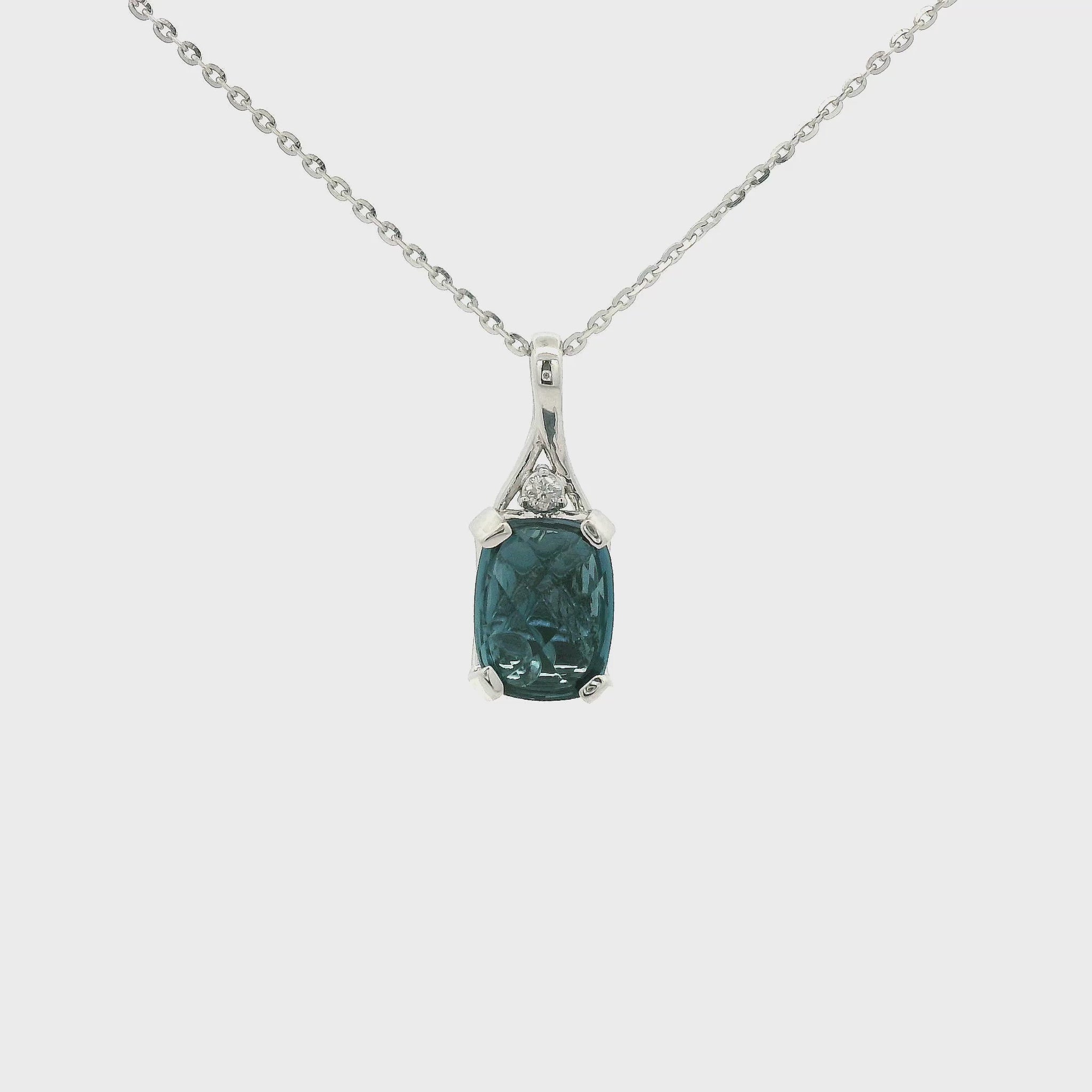 A White Gold Pendant with a prong set oval cut London Blue Topaz in the center with a bead behind it to help it sparkle and a Diamond set above the Topaz at Forever Rox Fine Jewelry, Lake Tahoes Best Jewelry Store
