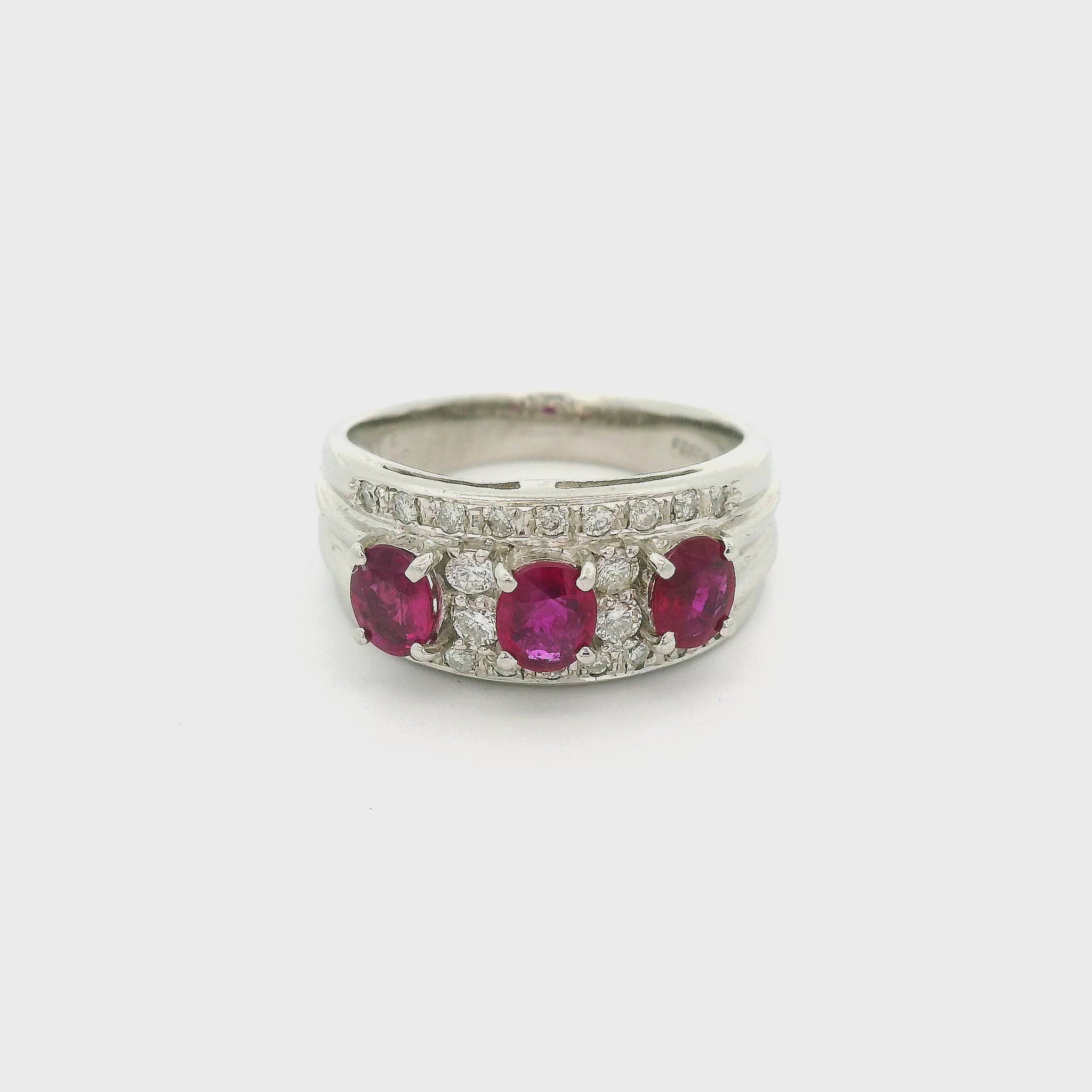 A Platinum Ring with three prong set oval cut natural Rubies in the center with adiamonds all around them at Forever Rox Fine Jewelry, Lake Tahoes Best Jewelry Store