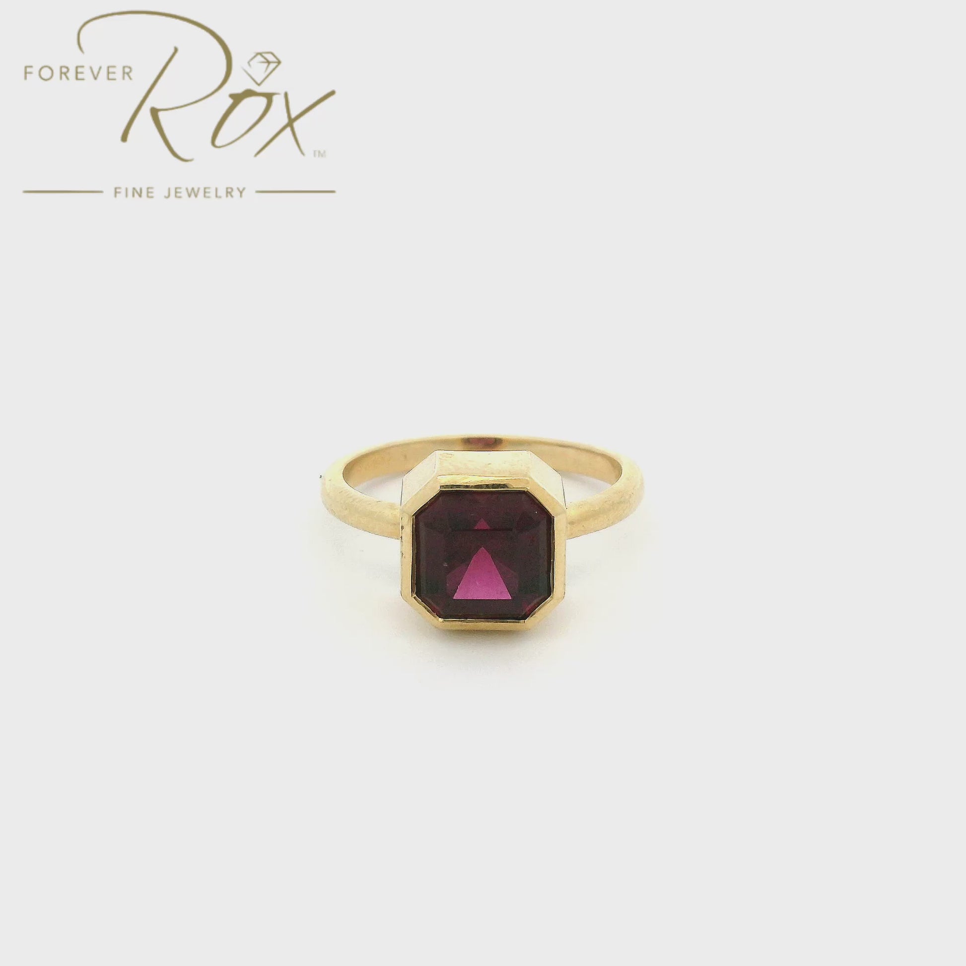 A Yellow Gold Ring with a bezel set octagon cut natural Rhodolite Garnet in the center at Forever Rox Fine Jewelry, Lake Tahoes Best Jewelry Store