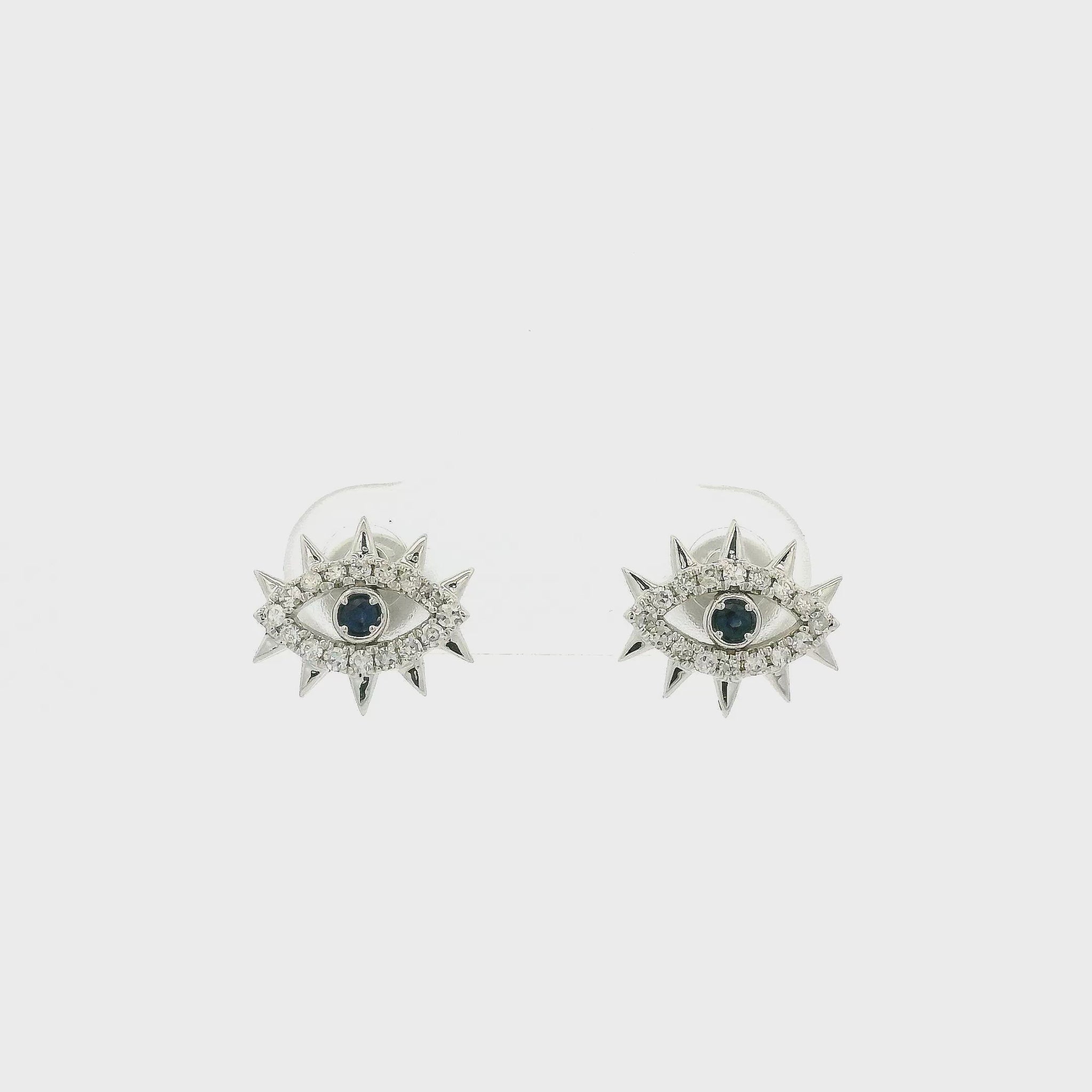 A Pair of White Gold Evil Eye Stud Earrings with bezel set round cut natural Sapphires in the center & diamond accents at Forever Rox Fine Jewelry, Lake Tahoes Best Jewelry Store