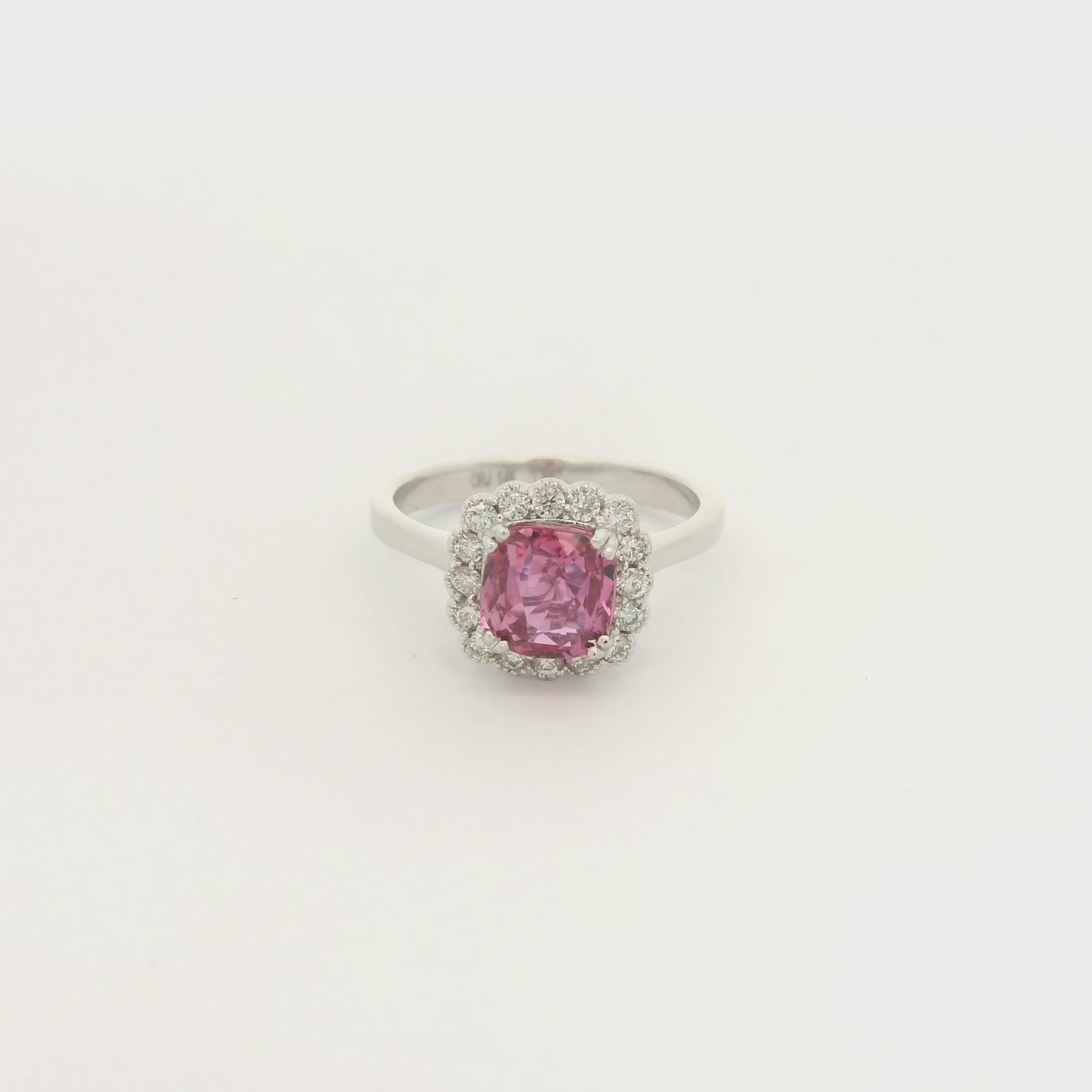 A White Gold Ring with a prong set cushion cut natural Certified Padparadscha Sapphire in the center with a diamond halo at Forever Rox Fine Jewelry, Lake Tahoes Best Jewelry Store
