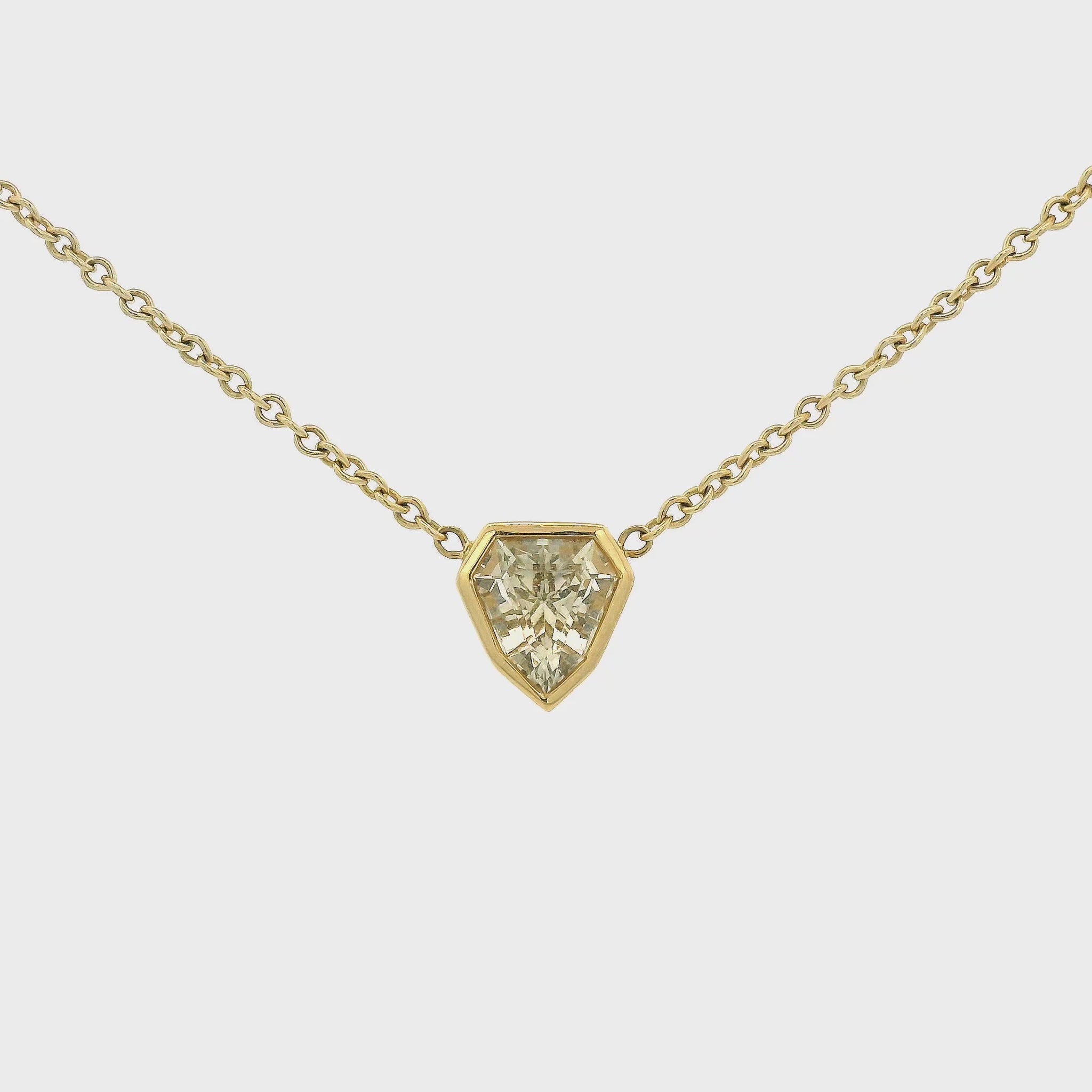 A Yellow Gold Pendant with a bezel set white fancy cut Sapphire in the center with a chain attached at Lake Tahoes best Jewelry Store, Forever Rox Fine Jewelry