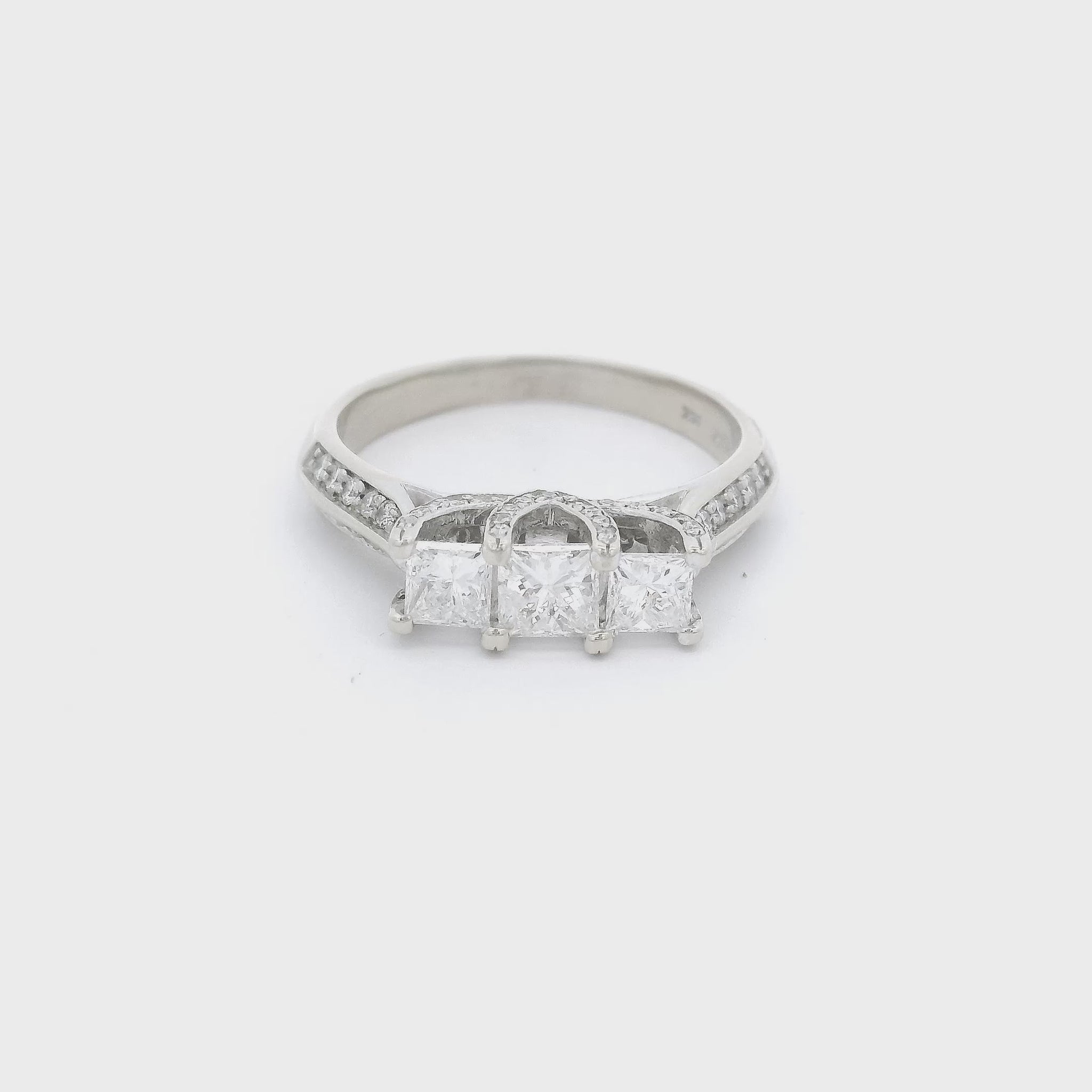 Three Princess cut diamonds and round diamonds set in a white gold ring at Forever Rox Fine Jewelry