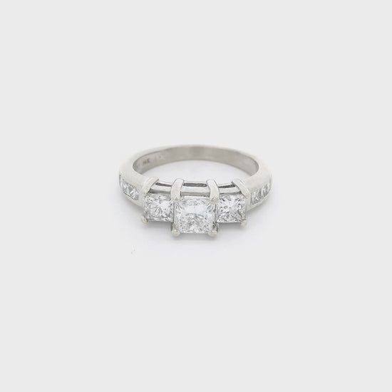 White Gold ring with one big princess cut diamond in the center and two smaller princess cut diamonds next to it and six princess cut diamonds channel set in the shank at Forever Rox FIne Jewelry 