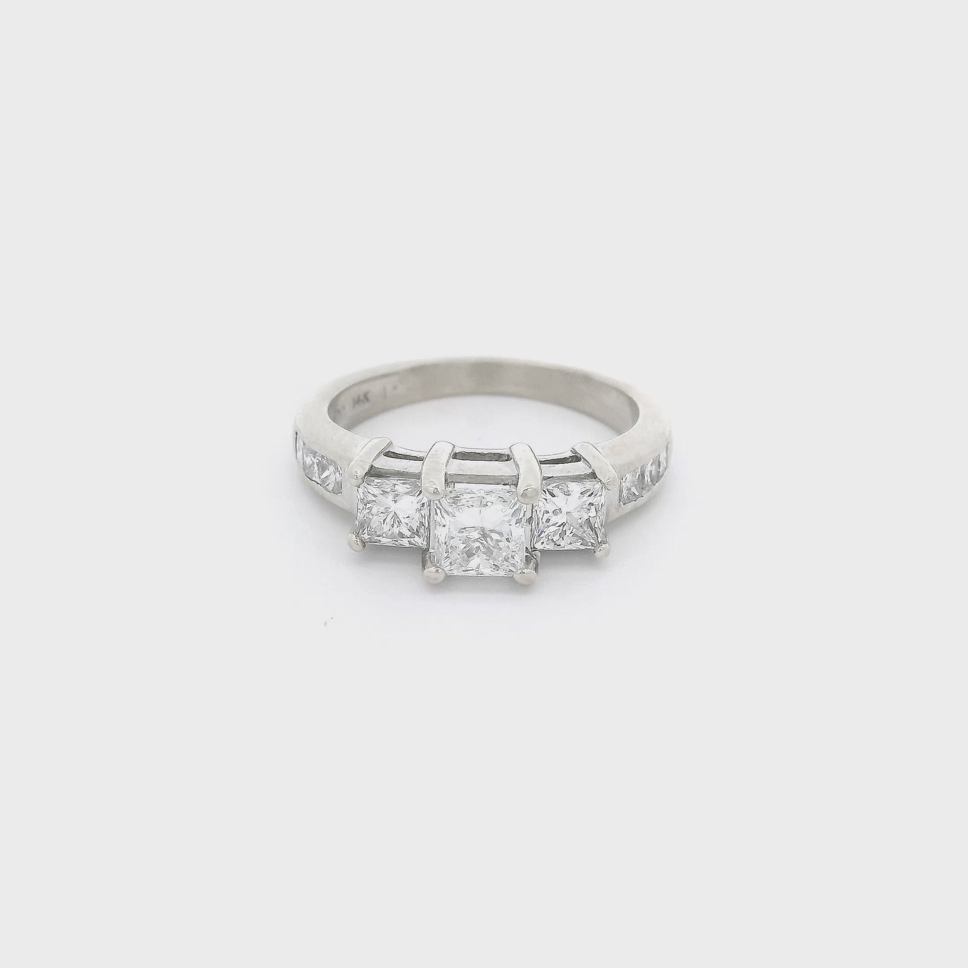 White Gold ring with one big princess cut diamond in the center and two smaller princess cut diamonds next to it and six princess cut diamonds channel set in the shank at Forever Rox FIne Jewelry 