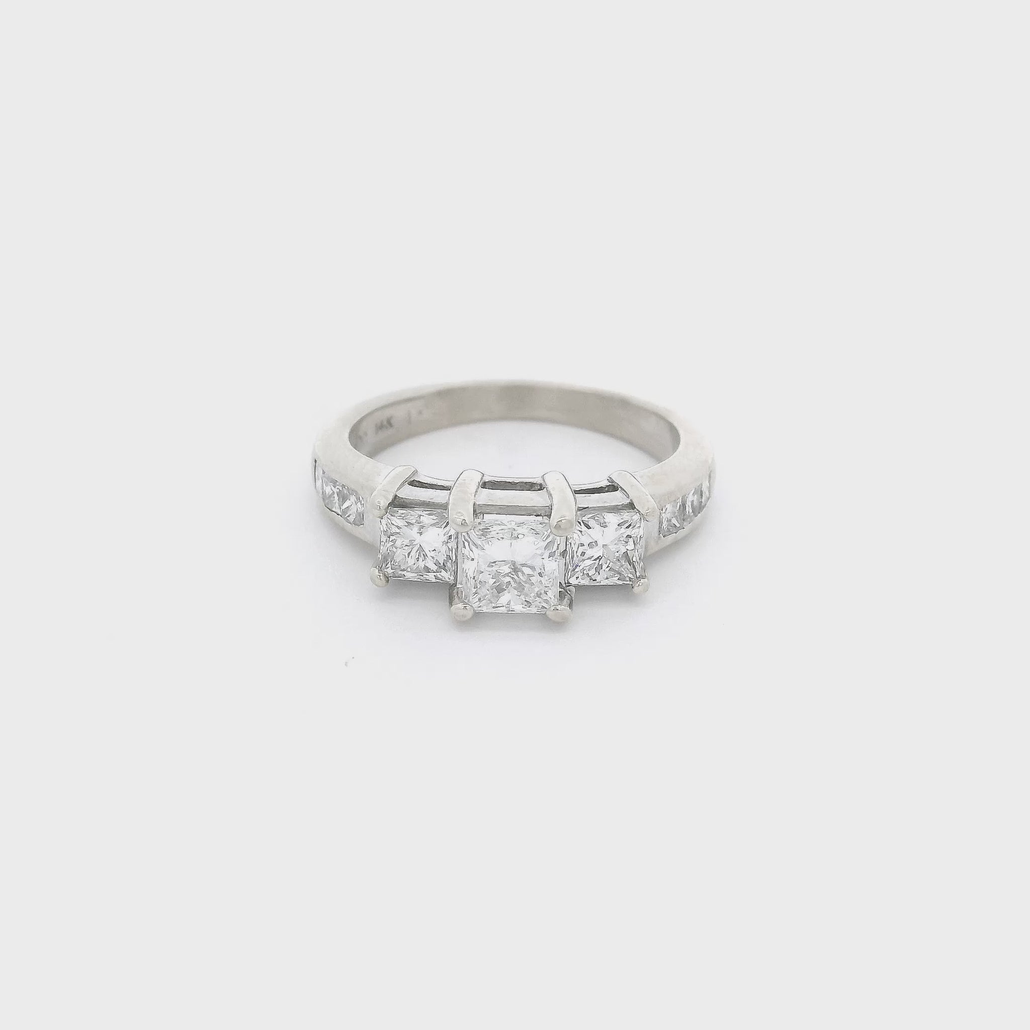 White Gold ring with one big princess cut diamond in the center and two smaller princess cut diamonds next to it and six princess cut diamonds channel set in the shank at Forever Rox FIne Jewelry 
