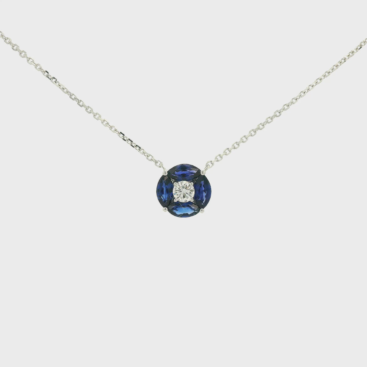 A White Gold Pendant with a round cut diamond in the center & 4 marquise cut Sapphires in a circle around it at Forever Rox Fine Jewelry, Lake Tahoes Best Jewelry Store