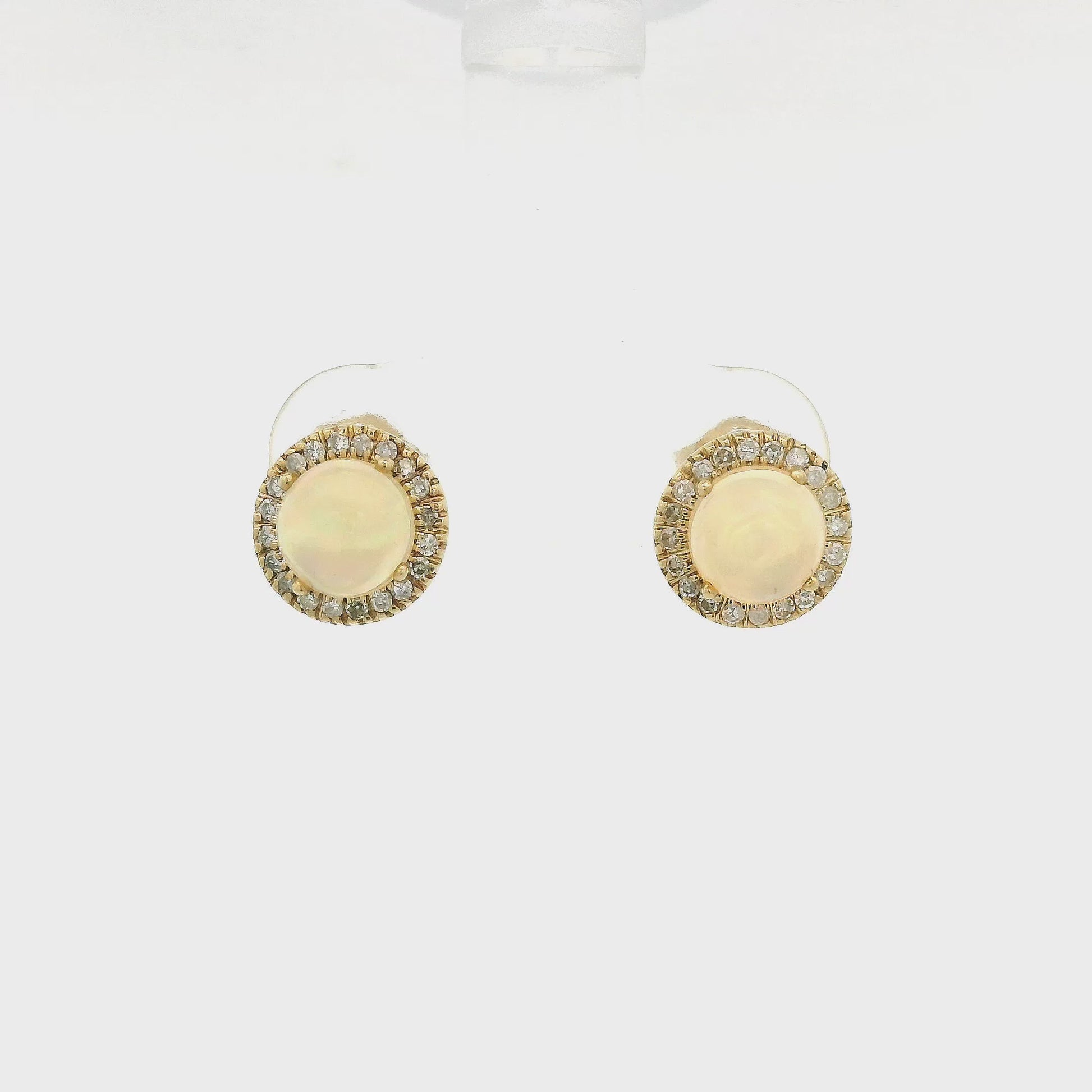 A Pair of Yellow Gold Studs with prong set natural Ethiopian Opals in the center with a diamond halo at Forever Rox Fine Jewelry, Lake Tahoes Best Jewelry Store
