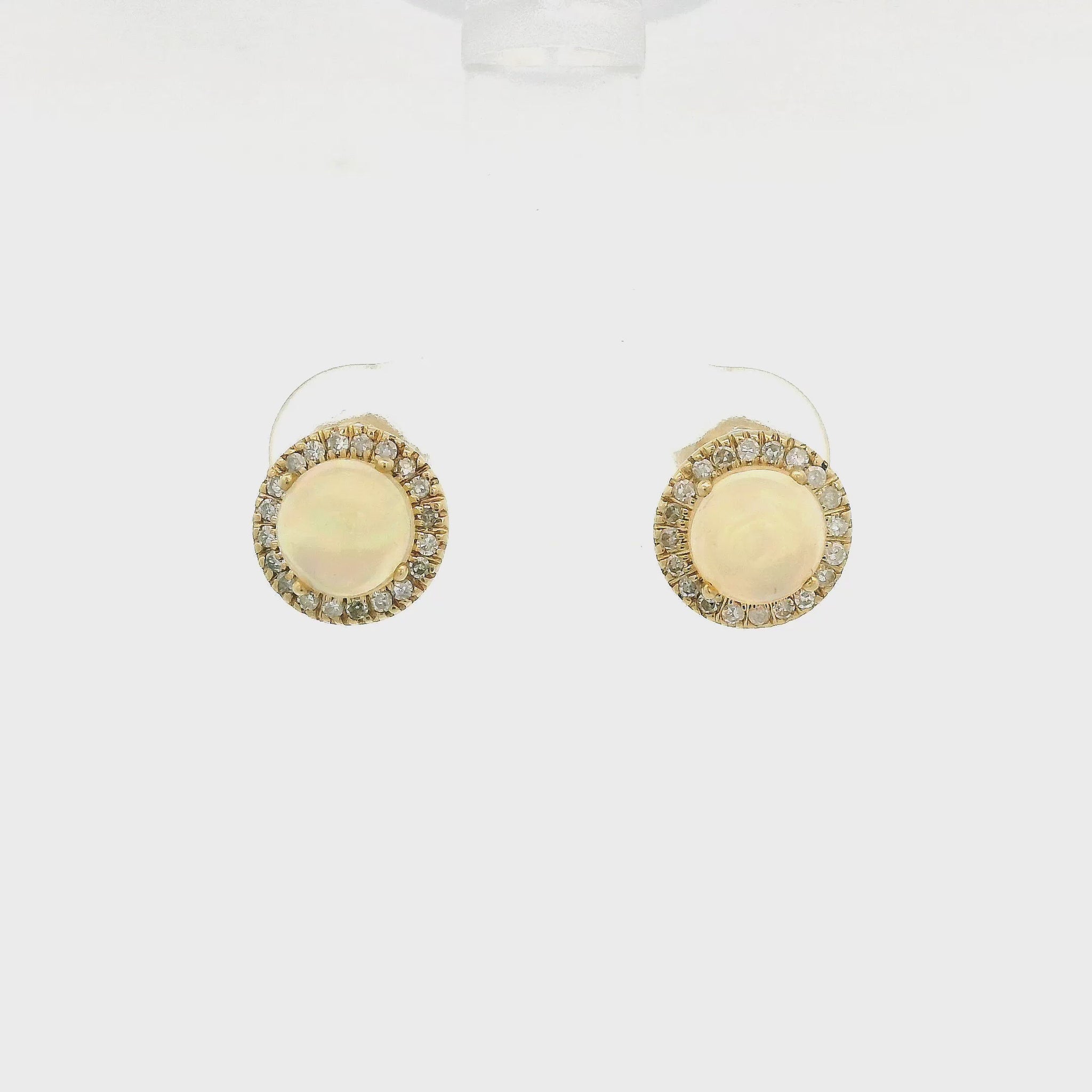 A Pair of Yellow Gold Studs with prong set natural Ethiopian Opals in the center with a diamond halo at Forever Rox Fine Jewelry, Lake Tahoes Best Jewelry Store
