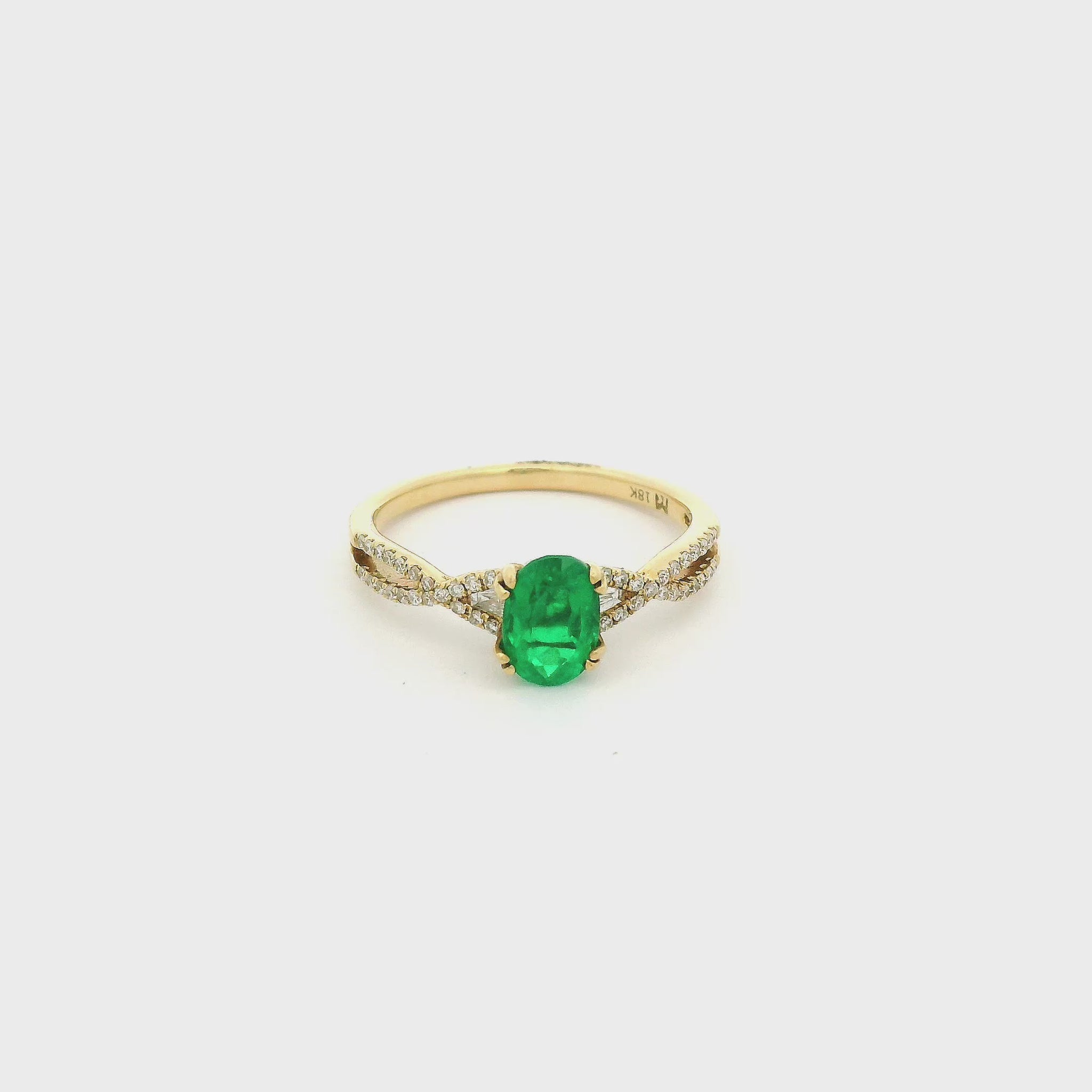 A Yellow Gold Ring with a prong set oval cut Emerald in the center with triangle & Round Cut Diamonds at Forever Rox Fine Jewelry, Lake Tahoes Best Jewelry Store