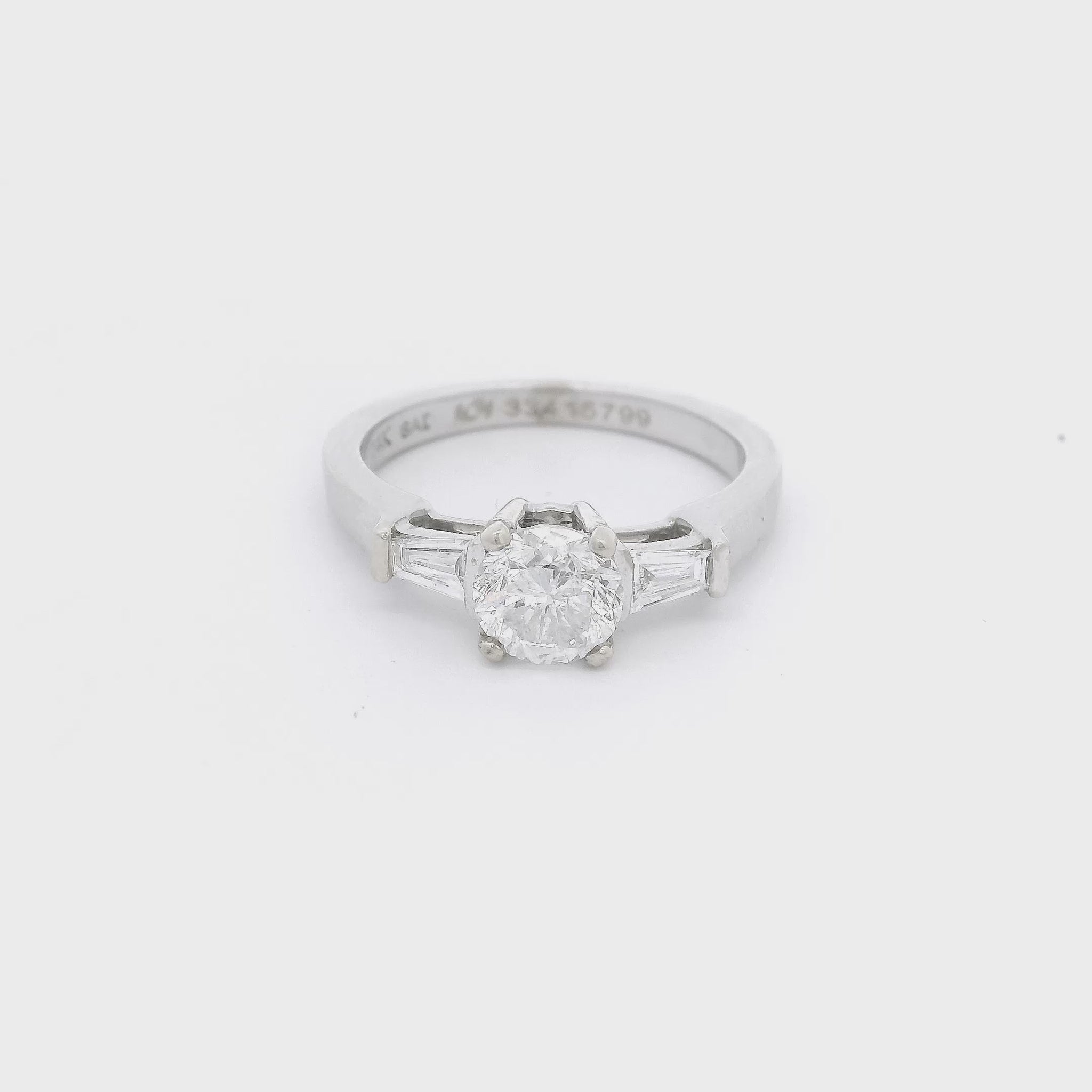Round Cut Diamond & 2 Tapered Baguette Cut Diamonds set in a white gold ring at Forever Rox Fine Jewelry