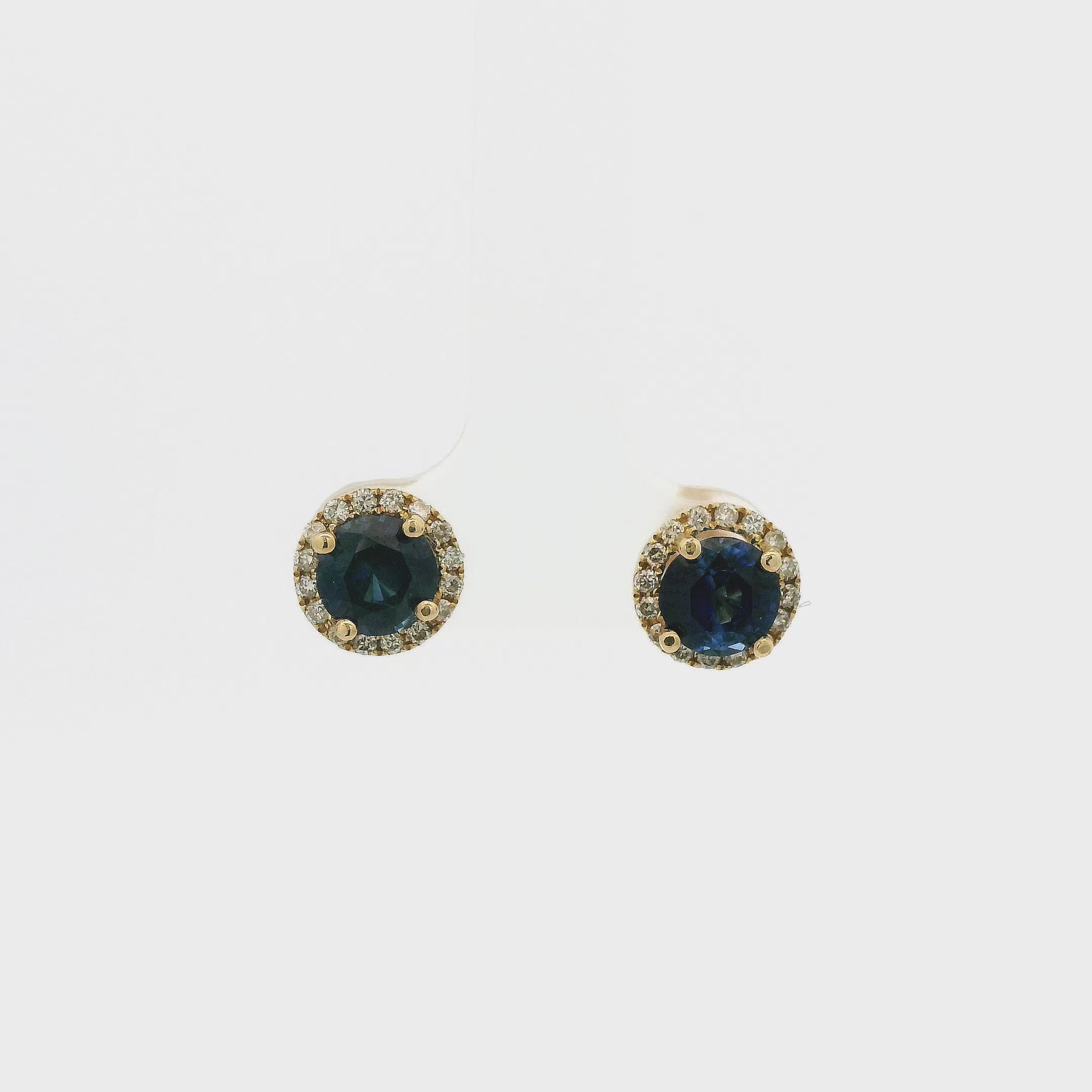 A Pair of Yellow Gold Studs with prong set round cut natural Sapphires in the center with a diamond halo at Forever Rox Fine Jewelry, Lake Tahoes Best Jewelry Store