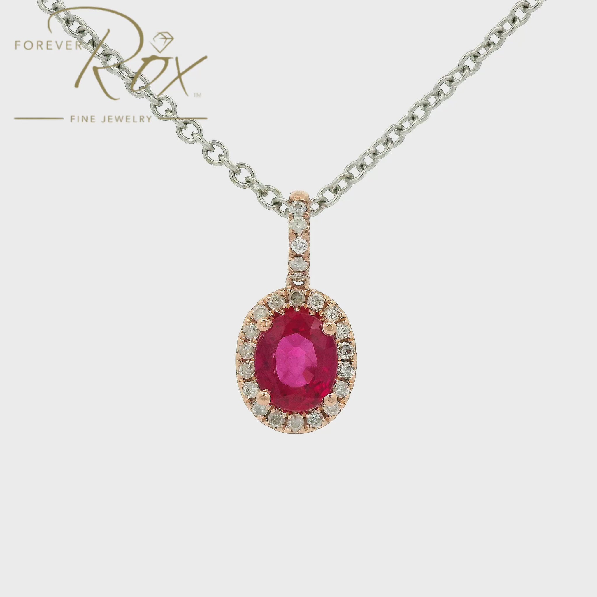 Custom Pinkish Red Ruby set in a rose gold diamond halo setting with a diamond bail at Forever Rox Fine Jewelry