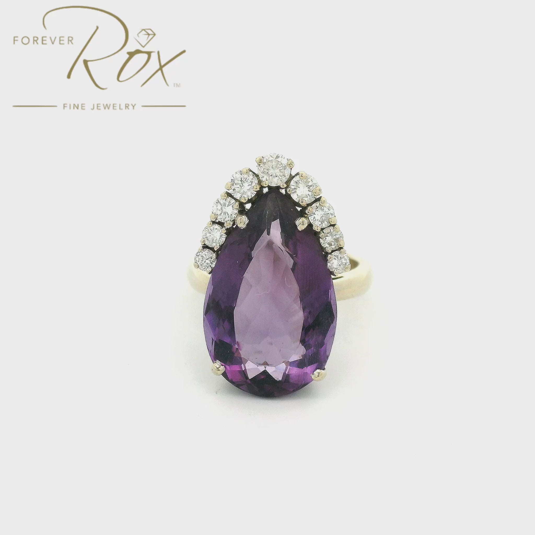 Purple pear shape Amethyst set in a white gold ring with diamonds surround teh top of the stone at Forever Rox Fine Jewelry
