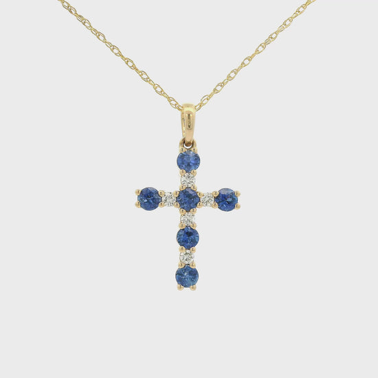 A Yellow Gold Cross Pendant with 6 prong set round cut blue Sapphires and 5 rounds Diamonds at Forever Rox Fine Jewelry, Lake Tahoes Best Jewelry Store