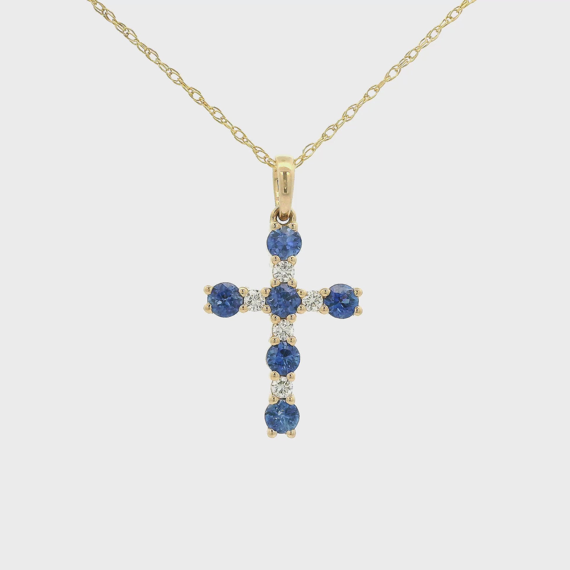 A Yellow Gold Cross Pendant with 6 prong set round cut blue Sapphires and 5 rounds Diamonds at Forever Rox Fine Jewelry, Lake Tahoes Best Jewelry Store