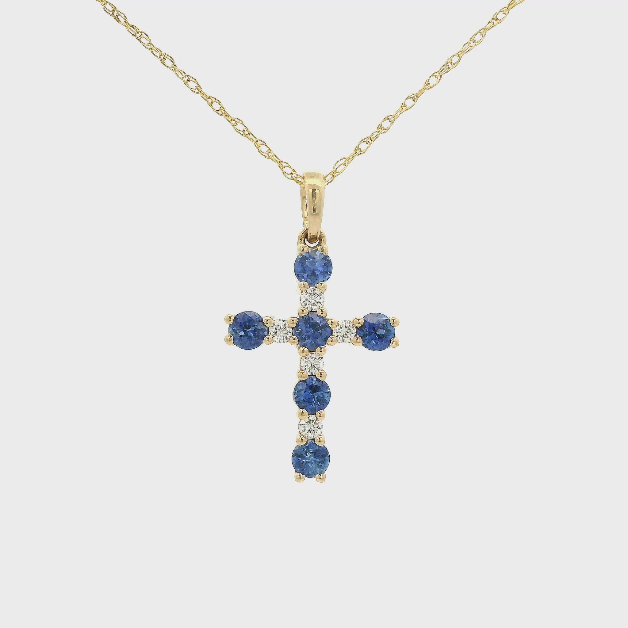 A Yellow Gold Cross Pendant with 6 prong set round cut blue Sapphires and 5 rounds Diamonds at Forever Rox Fine Jewelry, Lake Tahoes Best Jewelry Store