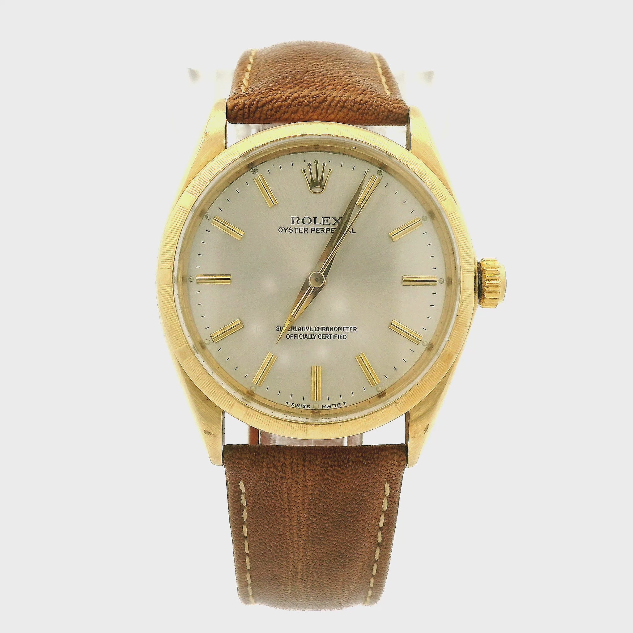 A vintage Rolex Oyster Perpetual watch with a gold-tone case, cream-colored dial, and a brown leather strap, shown against a plain white background at Forever Rox Fine Jewelry, Lake Tahoes Best Jewelry Store
