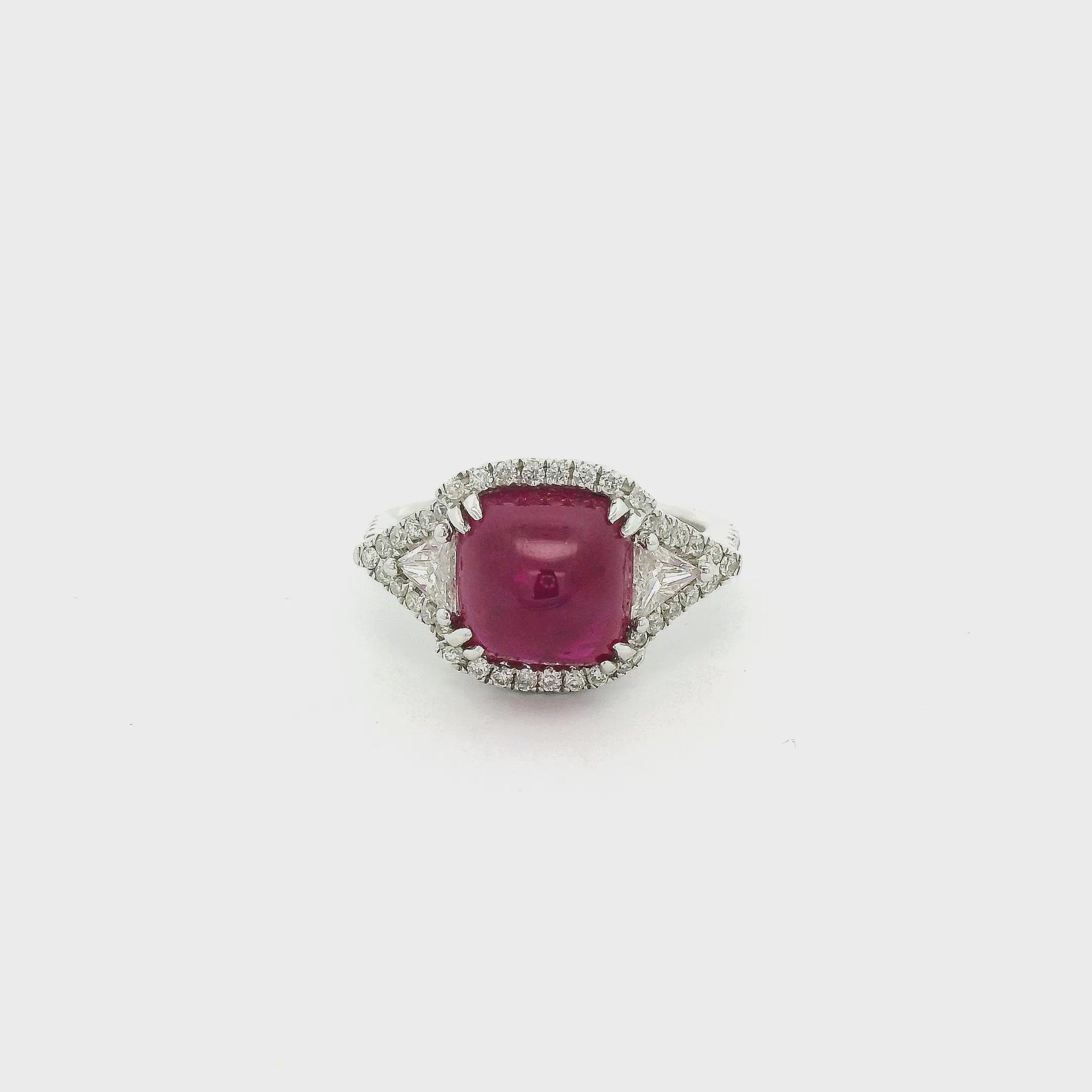 A White Gold Ring with a prong set sugarloaf cabochon GIA Certified natural Ruby in the center with two triangle cut diamonds and round cut diaomonds at Forever Rox Fine Jewelry, Lake Tahoes Best Jewelry Store