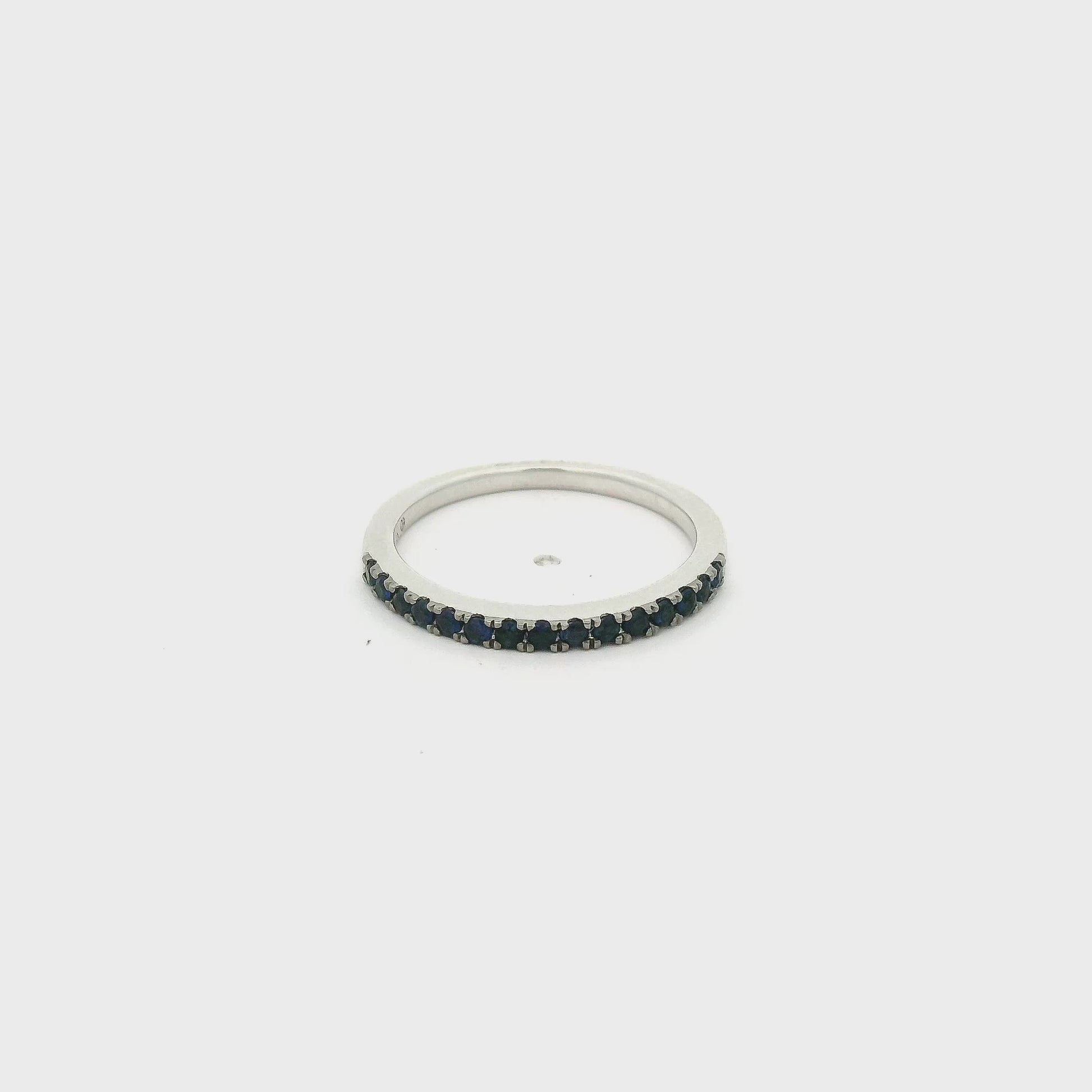A White Gold Eternity Band with natural Dark Blue Sapphires half way around at Forever Rox Fine Jewelry, Lake Tahoes Best Jewelry Store